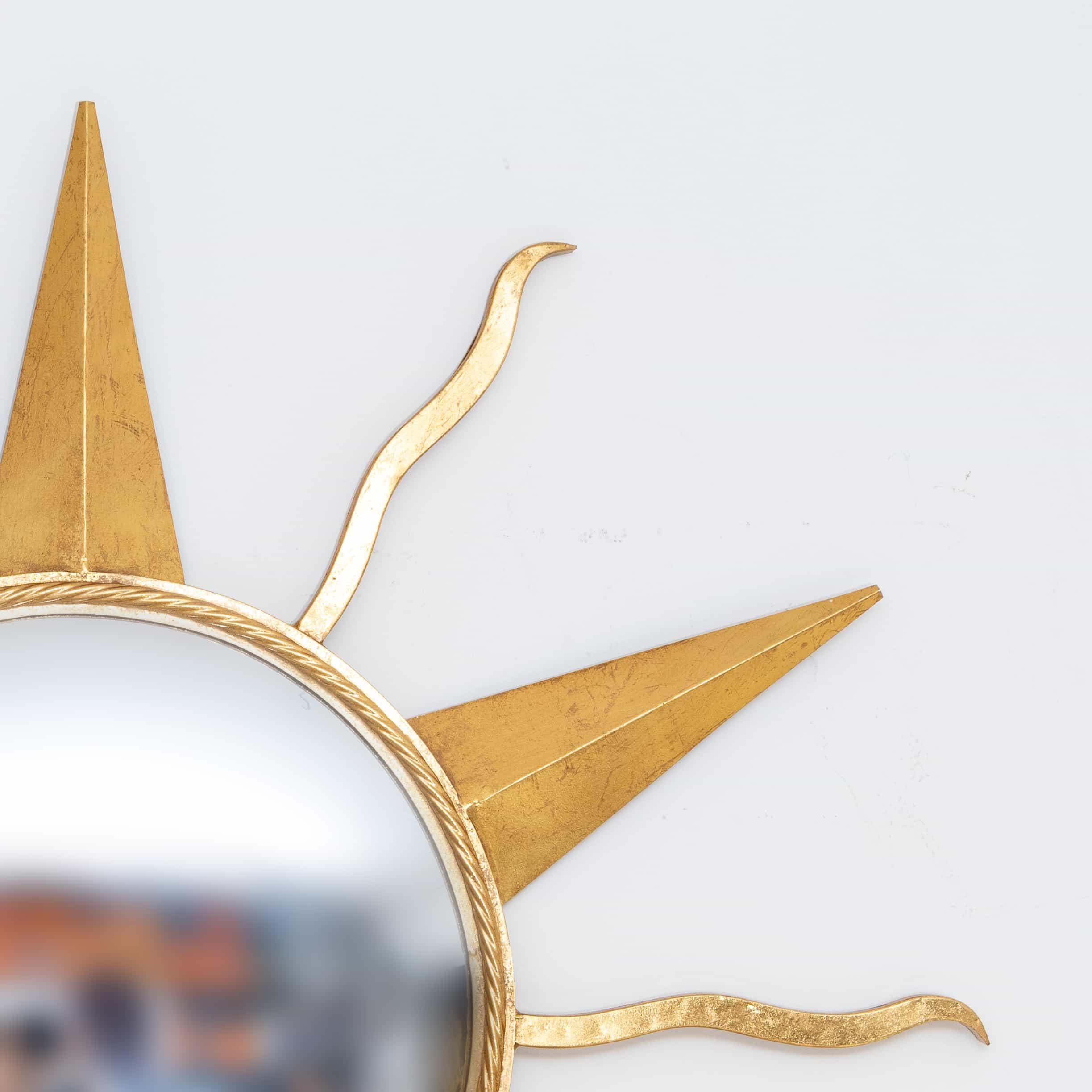 Golden metal wall mirror in the shape of a sun from the 21st century.