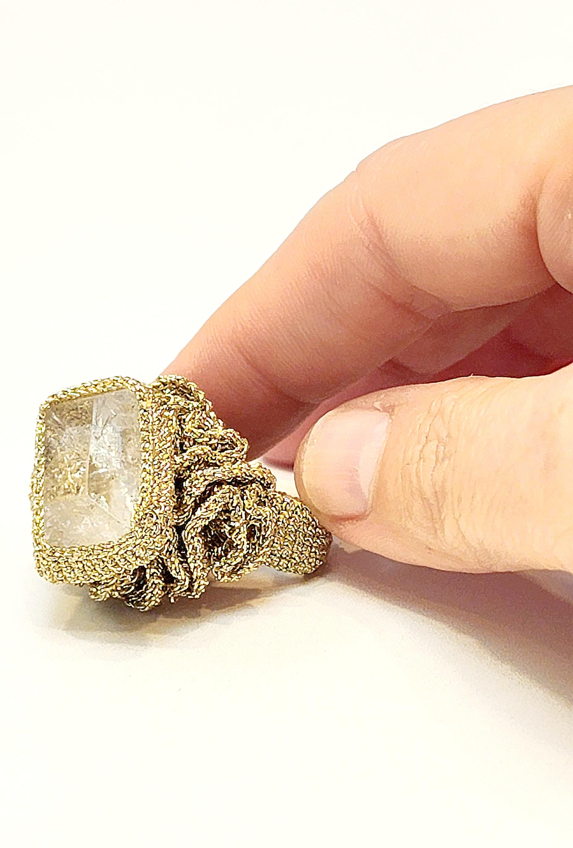One of a kind handcrafted Crochet ring. This is a unique statement Cocktail ring. A beautiful clear rough baguette shaped Crystal Stone Crochet on top of a wavelike round design. The ring is very light as it is Crochet with Golden smooth passing