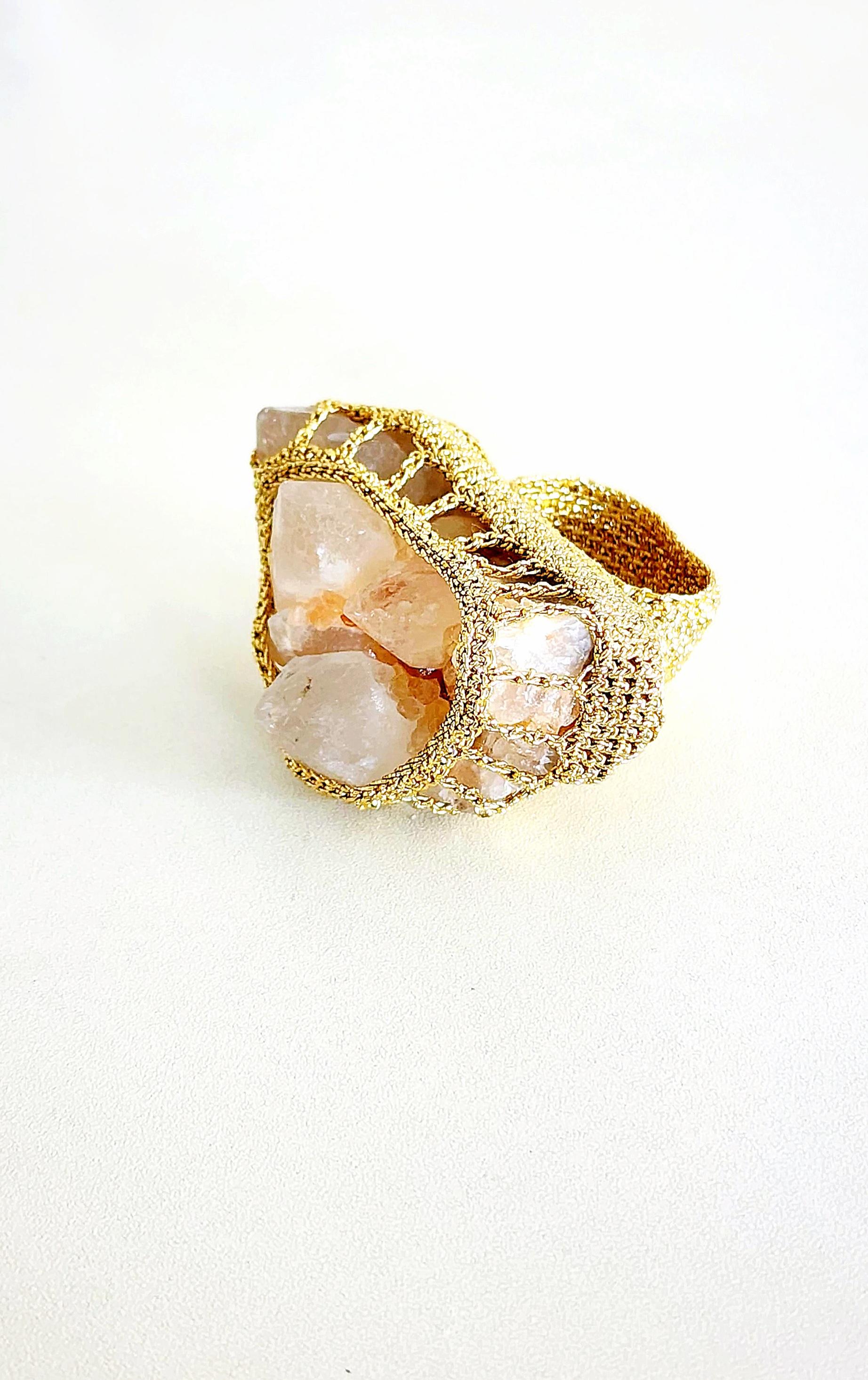 This is a one of a kind crochet ring. The stone is a rough cut Rose Quartz. The crochet cradles the stone beautifully. It is a statement ring. Definetely a conversation starter. I let the stone dictate how the ring will end up looking.