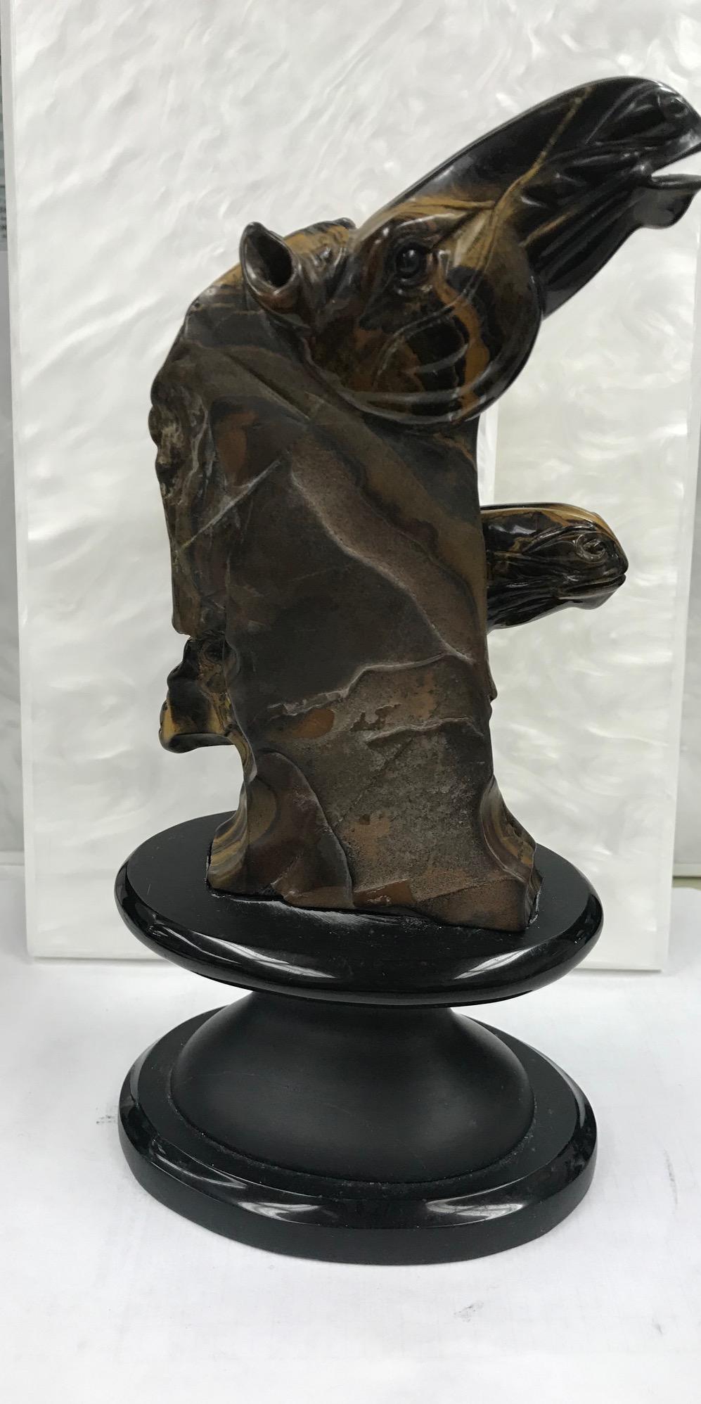 This stunning Golden Tiger Eye sculpture has a double horse head.
It sits on a black oval stand that is approximatly 4.5