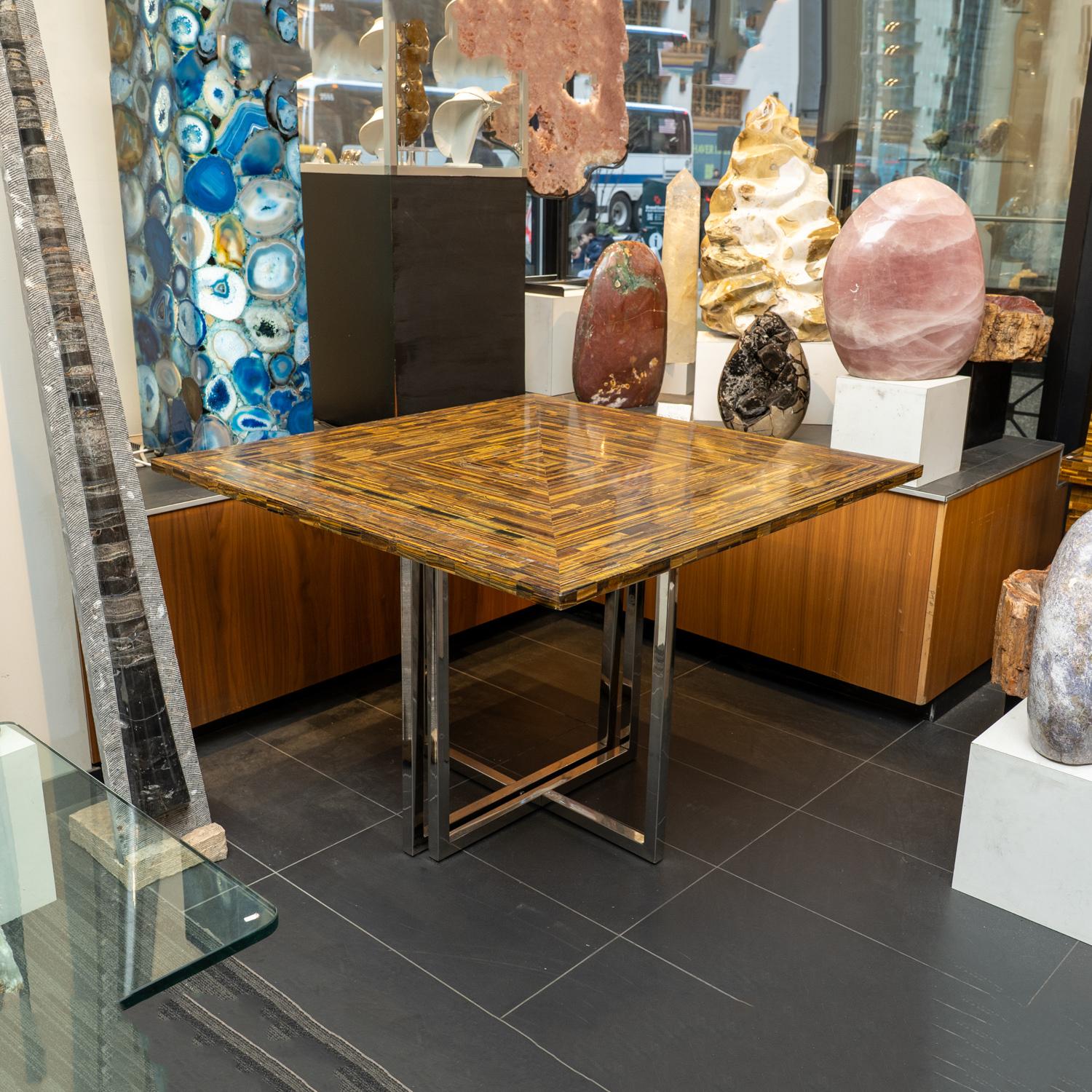 This incredible, unique, elegant and exquisite dining table. Tiger's eye has been meticulously cut into small pieces, then pieced together to create an intricate pattern.  There's a variety of uses for this table, it can be used as a guest table,