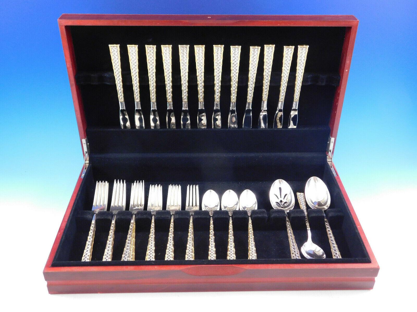 Golden Tradewinds by International sterling silver flatware set - 51 pieces. This pattern features a unique basket weave design and bamboo border with gold accent. This set includes:

12 Knives, 8 3/4
