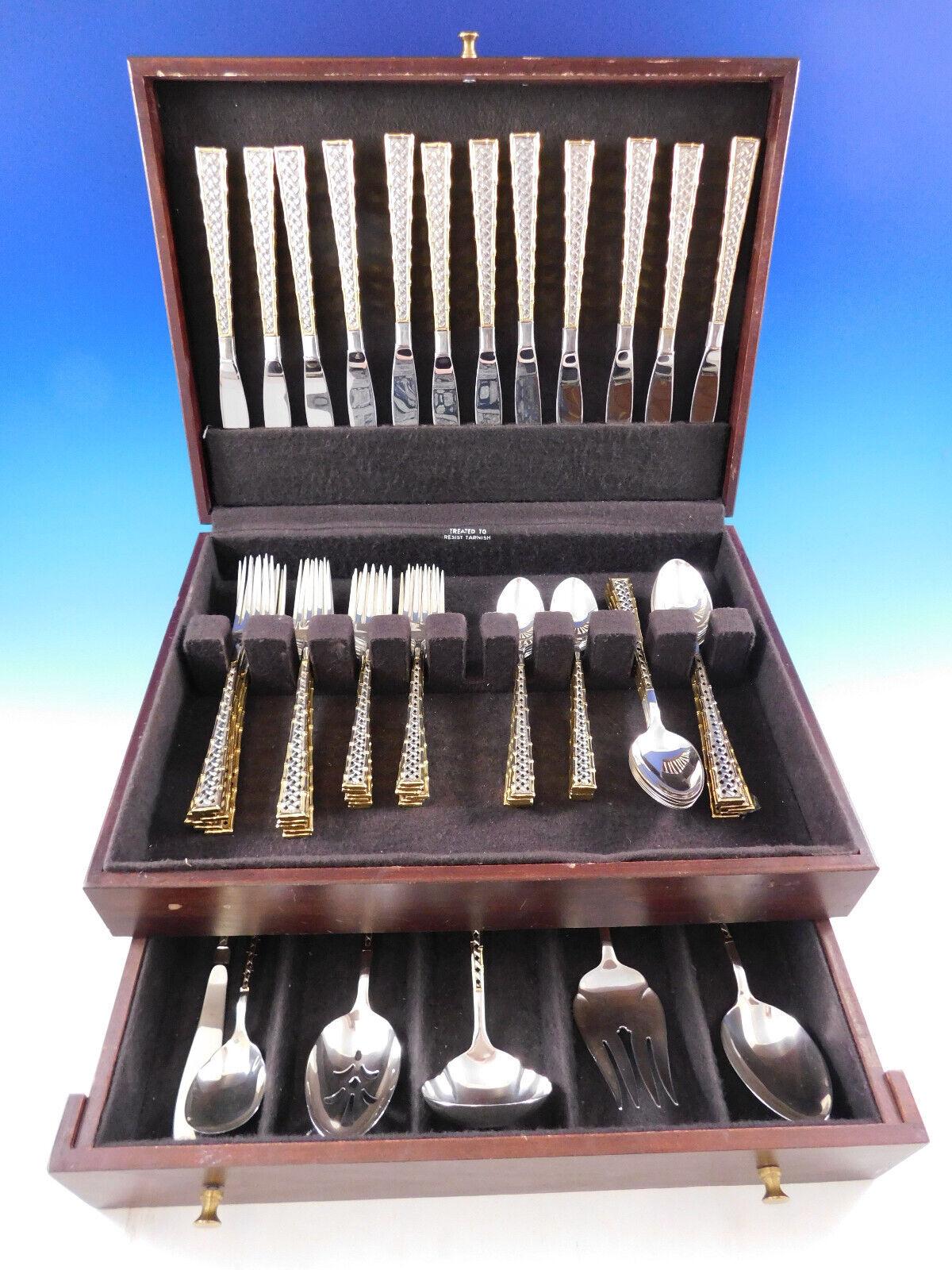 Gorgeous Golden Trade winds by International sterling silver flatware set - 66 pieces. This pattern features a basket weave design and bamboo border with gold accent. This set includes:
12 Knives, 8 3/4