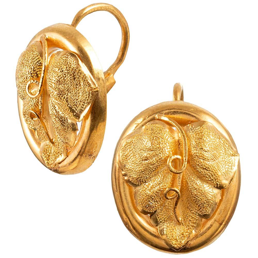 Made of 18 karat yellow gold and showcasing a lifelike rendering of a grape leaf in a polished golden bezel, these earrings would make a lovely gift for your favorite wine enthusiast. The organic theme and absence of gemstones makes them ideal for