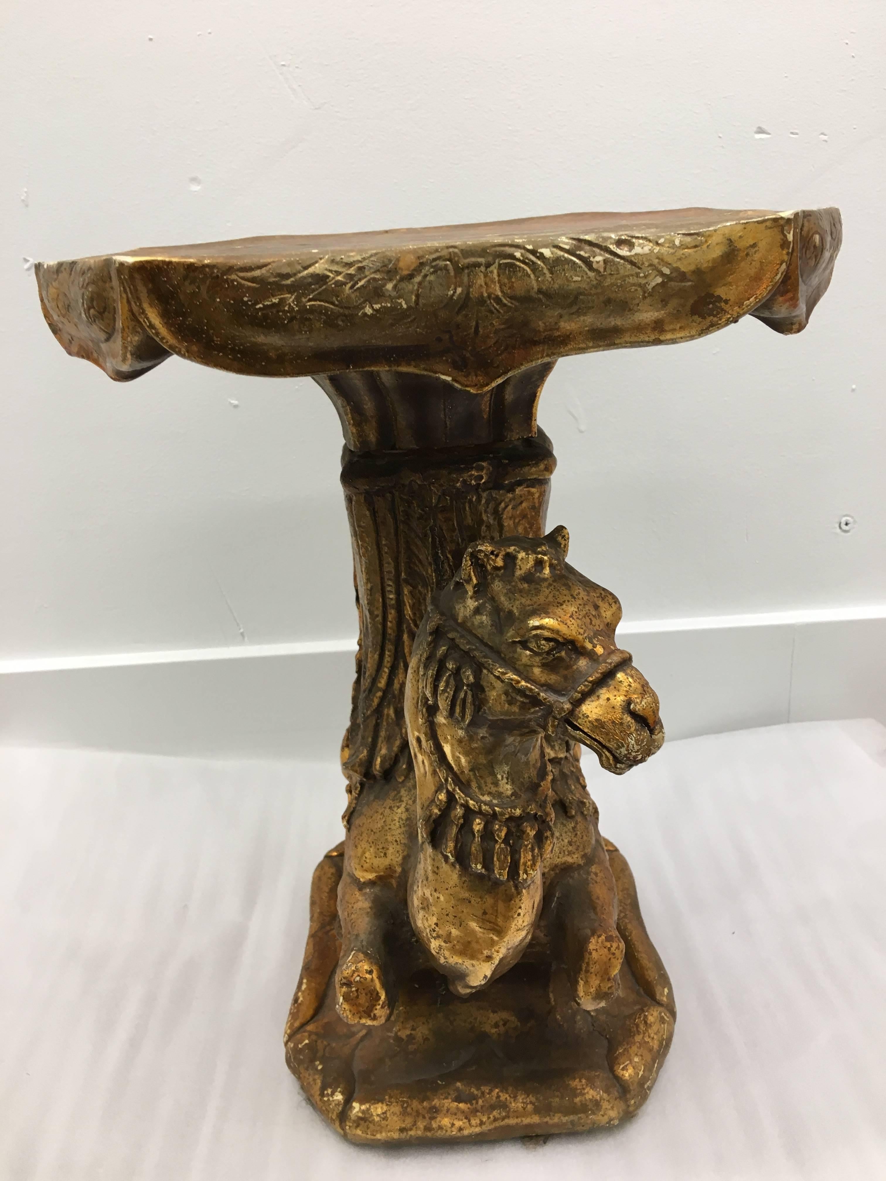 This diminutive vintage Moroccan style gilded camel table is perfect for aside a chair or sofa to place your drinks during a cocktail party. A piece of glass could also be added to increase the coverage.