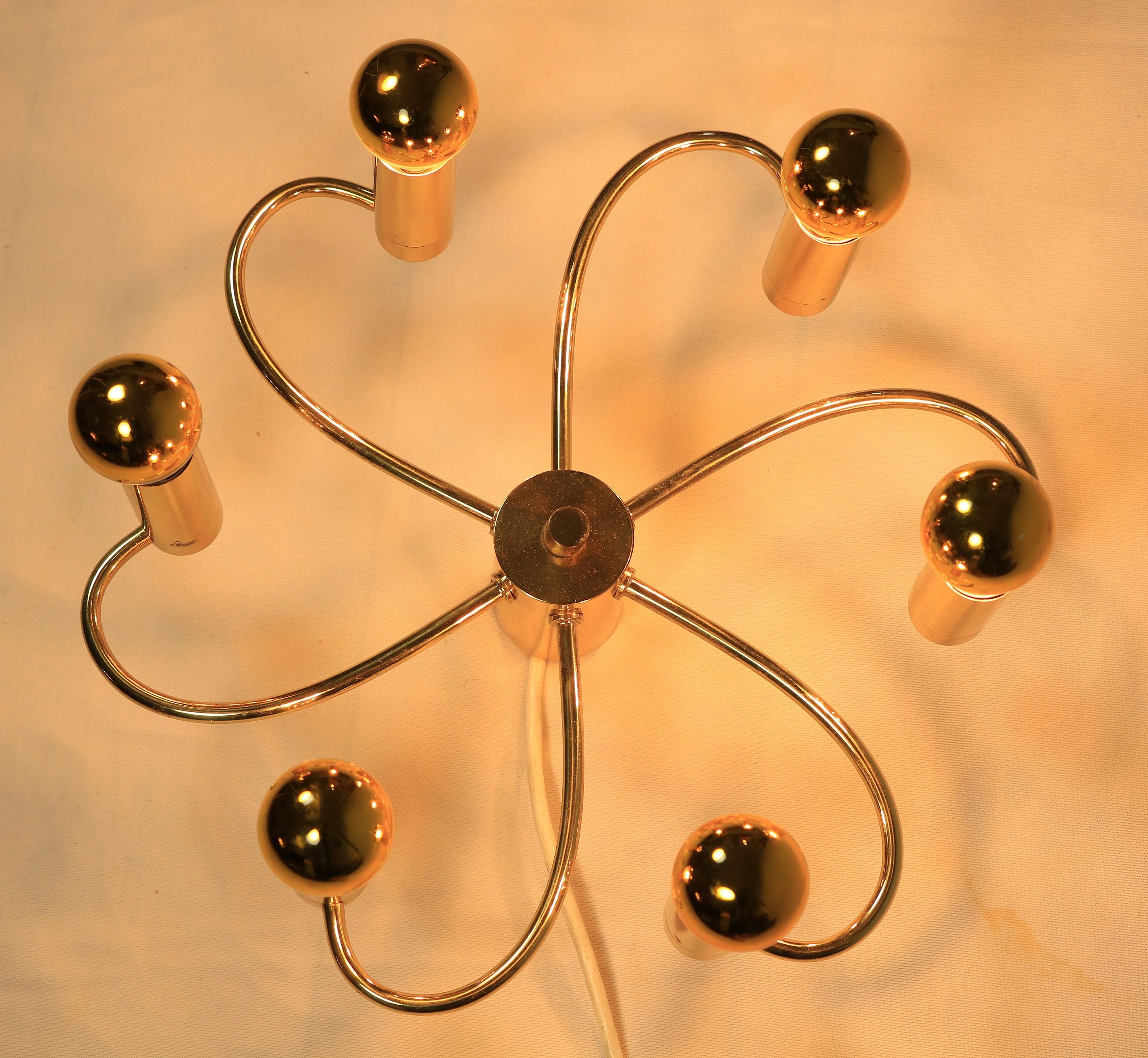Very decorative wall or ceiling lamp by Cosack.

Spiral brass arms with a total of six E14 sockets.
The golden head mirror bulbs are included and complete the elegant look.

Diameter: 35 cm / 13.8 inches.
