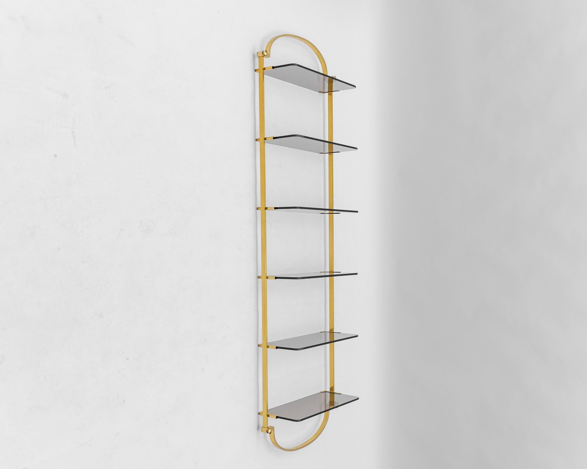 Golden wall shelf with six smoked glass shelves, Italy, 1960s

We also have a larger but slightly larger shelf from this series. 

A shelf floor has a small chip on the edge 