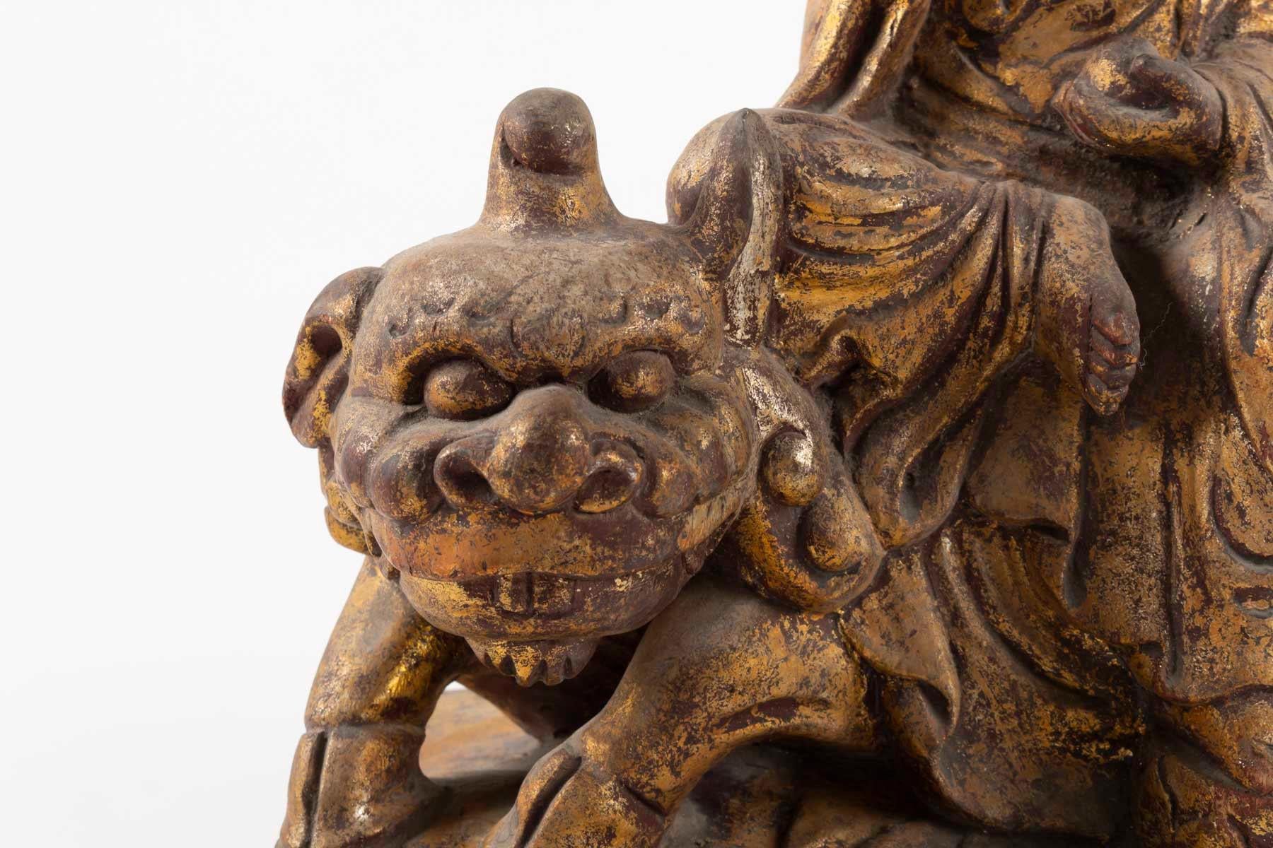 Golden wood Buddhist deity, seated on a lion, China, late 19th century
Measures: H 31cm, W 24cm, D 13cm.