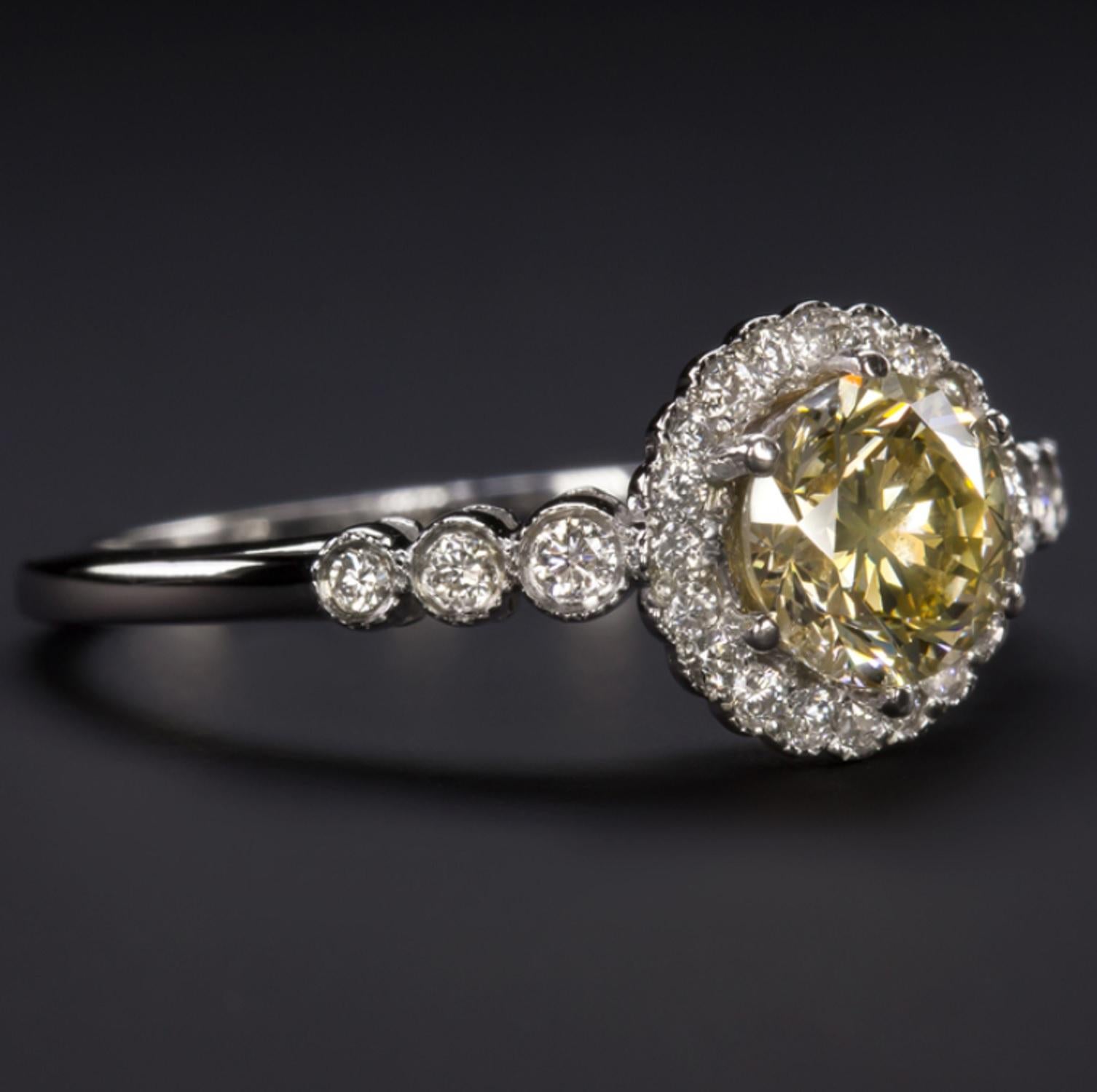 This yellow beautiful diamond ring is stunning! Consider the main stone weights approx. 0.90 carats and is absolutely eye clean
