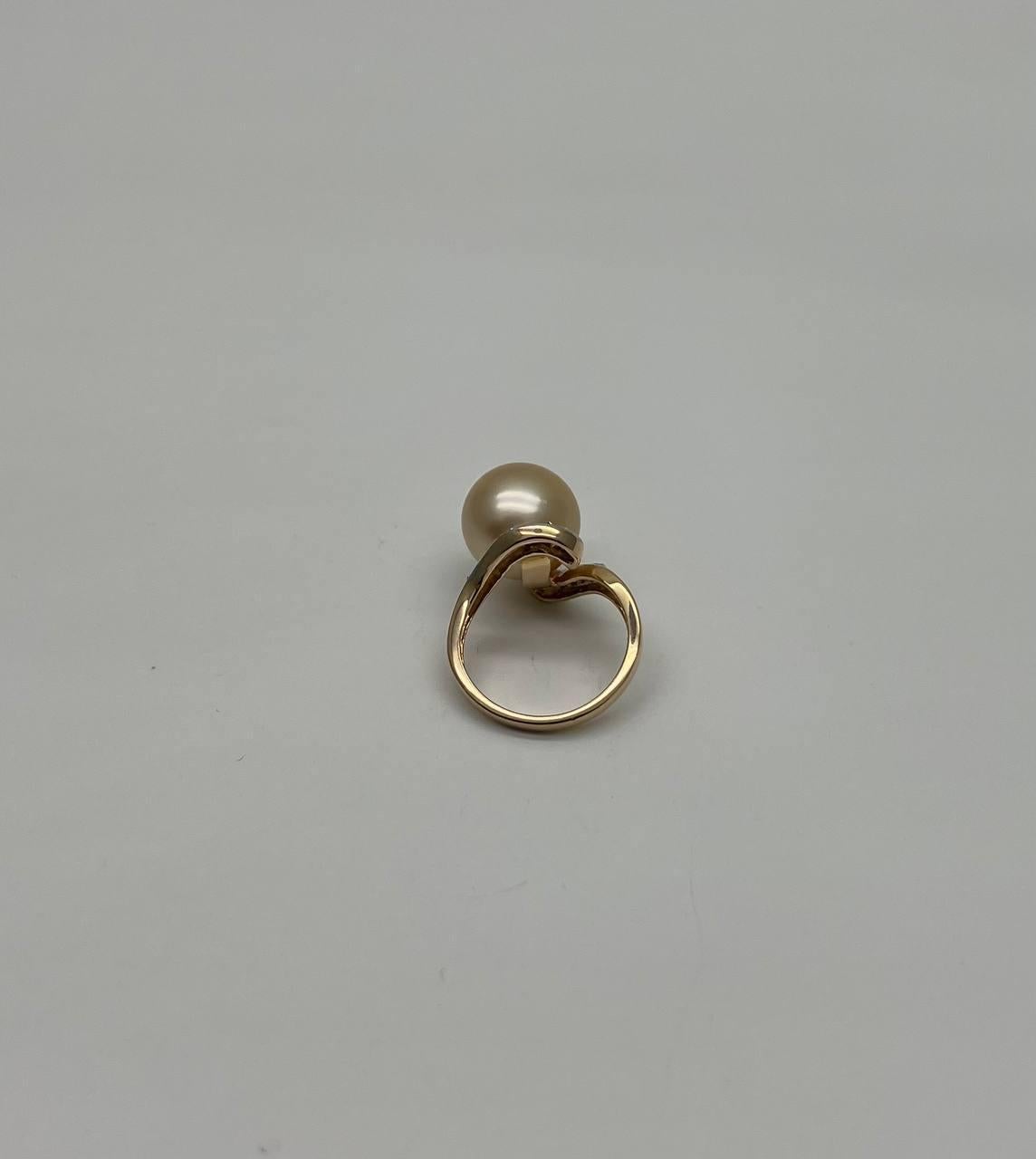 This elegant ring is crafted in gold. It features a lustrous golden yellow pearl set at the center, accentuated by a swirl of sparkling diamonds.
The diamonds are set in a graceful curve around the pearl.
14K Yellow Gold
12-13MM Size South Sea