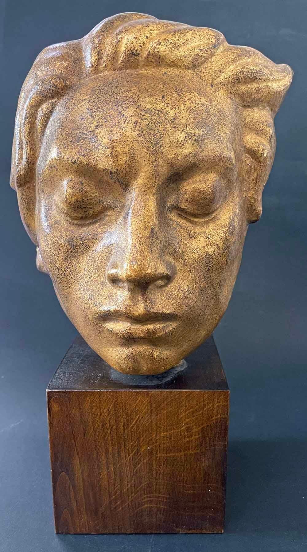 This strong, placid visage of a young man, eyes closed and hair flowing, was sculpted by John Lundqvist, sometimes compared to Carl Milles, who was Sweden's leading sculptor in the early 20th century.  Lundqvist has given his subject a rich, gilded