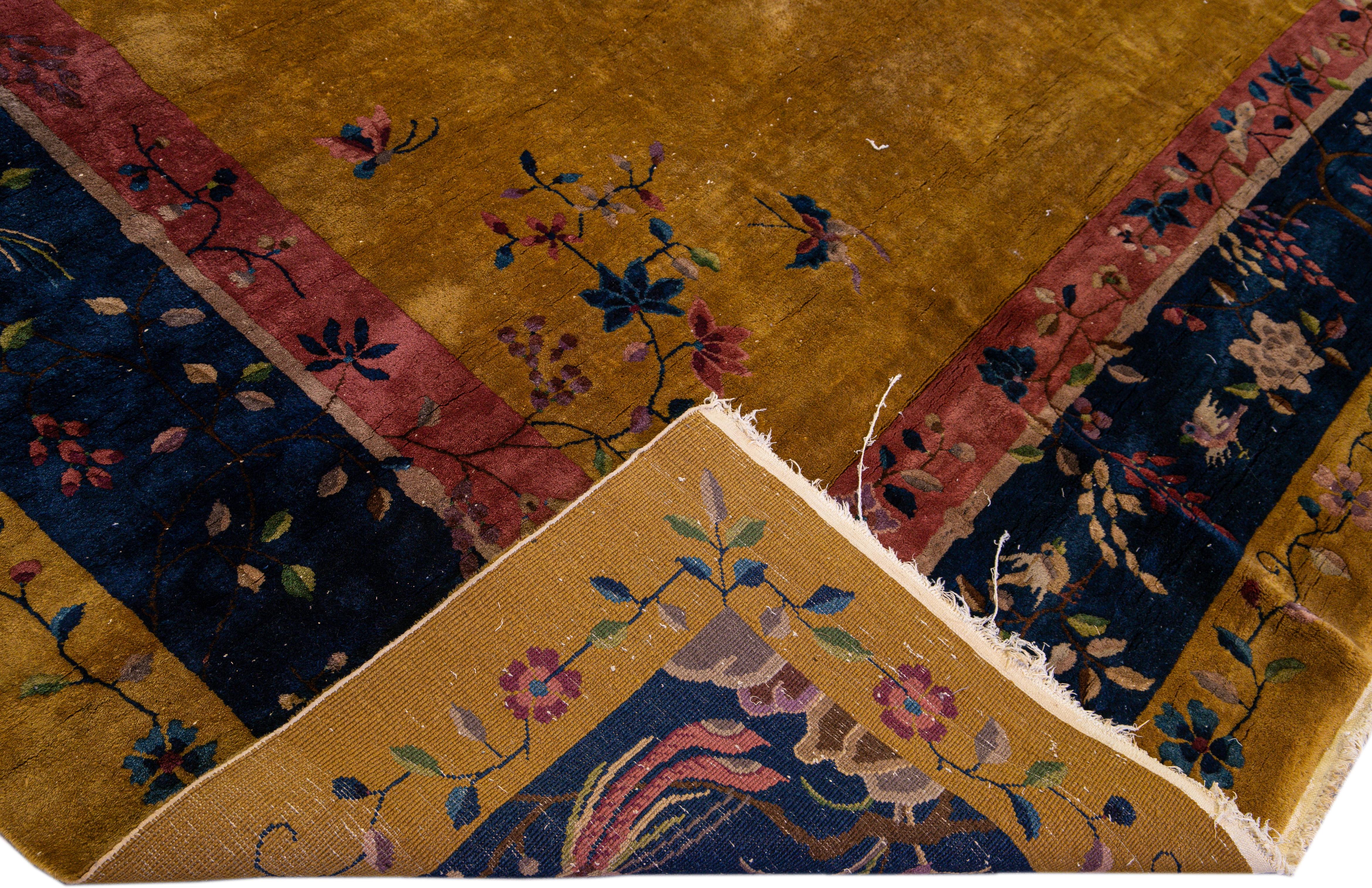 Beautiful antique Art Deco Chinese hand-knotted wool rug with a goldenrod field. This Chinese rug has a navy- blue and red frame multi-color accents in a gorgeous all-over traditional Chinese floral design. 

This rug measures: 11'11