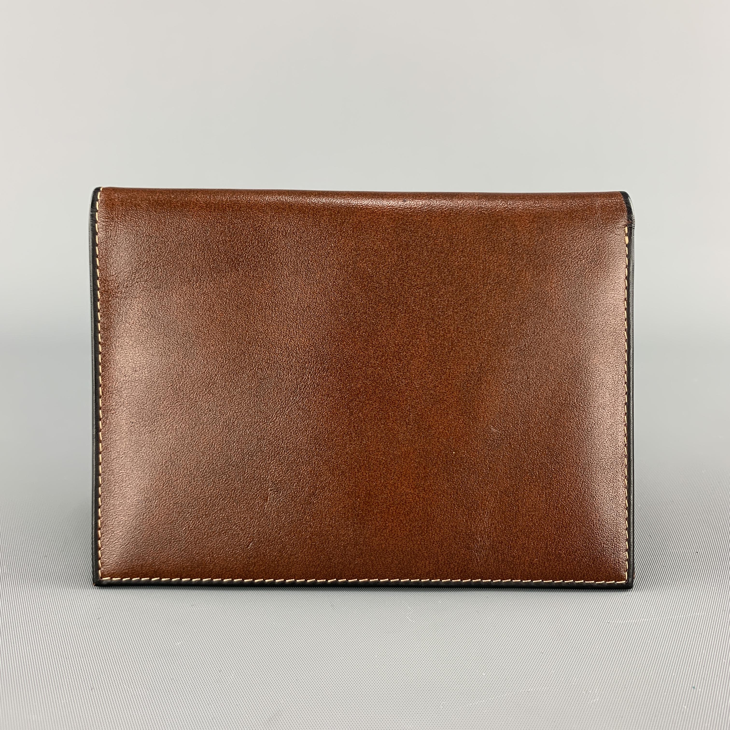 GOLDPFIEL travel wallet comes in tan brown leather with card slots, money compartment, and slot for passport. 

Excellent Pre-Owned Condition.

5.75 x 4.25 in.