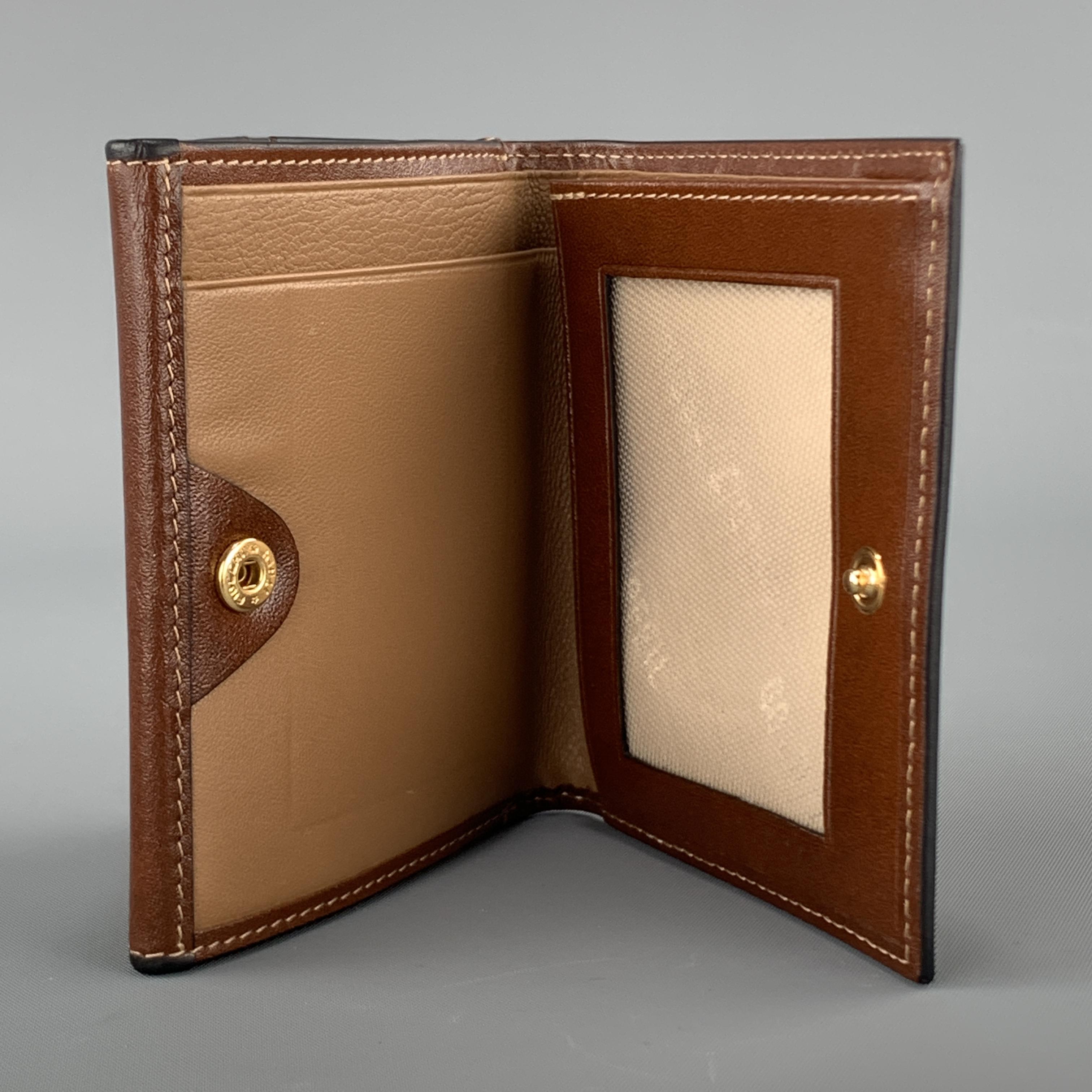 GOLDPFIEL travel wallet comes in tan brown leather with card slots, money compartment, and slot for passport. 

Excellent Pre-Owned Condition.

5.75 x 4.25 in.