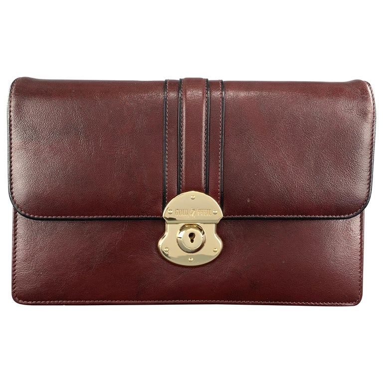 burgundy and gold clutch bag