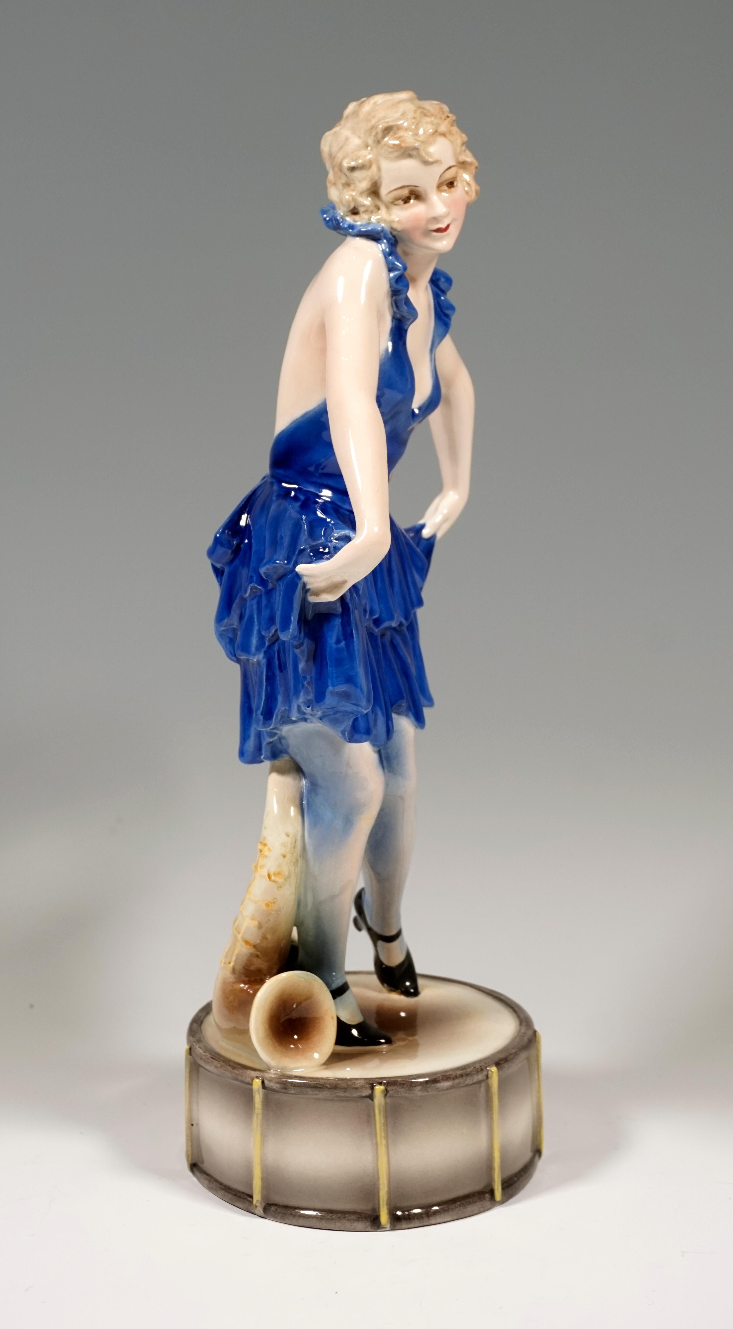 Very rare Goldscheider Art Deco ceramic figure of the 1920's:
Representation of a young variety dancer in pose. She wears a short, low-cut, blue ruffled dress, the skirt ends of which she holds up on both sides and curtsies.
The young lady is