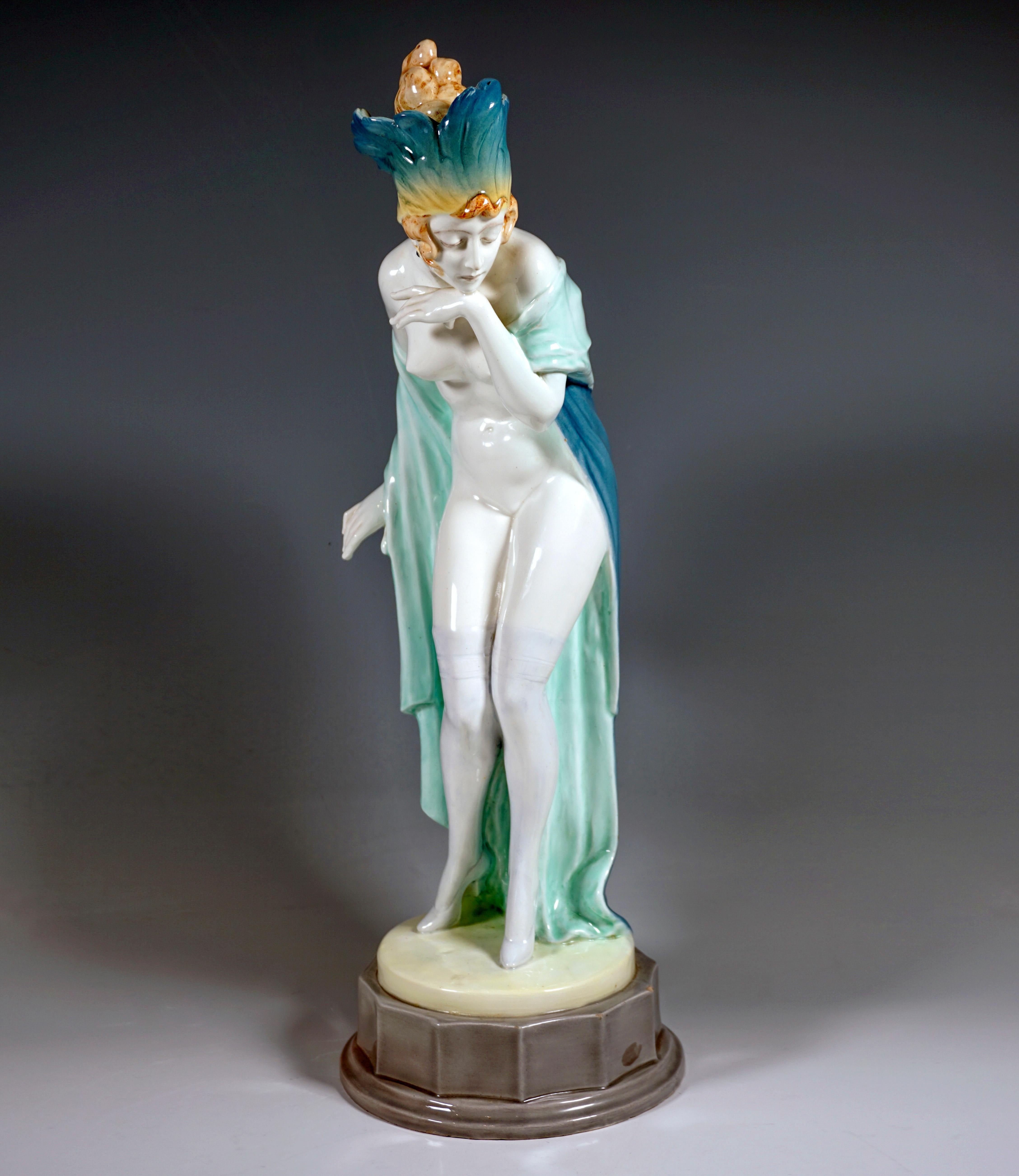 Impressive goldscheider Vienna ceramic figurine of the 1920s:
The young lady with artistically pinned up hair wears only transparent overknee stockings and high heels, as well as a headdress densely decorated with shaded turquoise-yellow feathers,