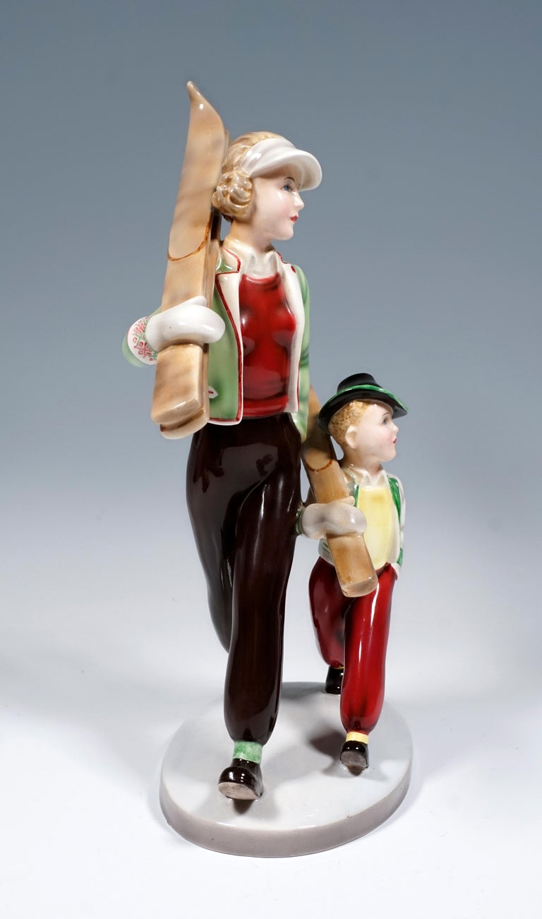Rare Goldscheider Vienna Figurine Group of the 1930s.
Two figures walking side by side, mother and child with shouldered skis. Both ware winter clothing that was common in Tyrol in the 1930s: wide trousers with cuffs and jackets in traditional