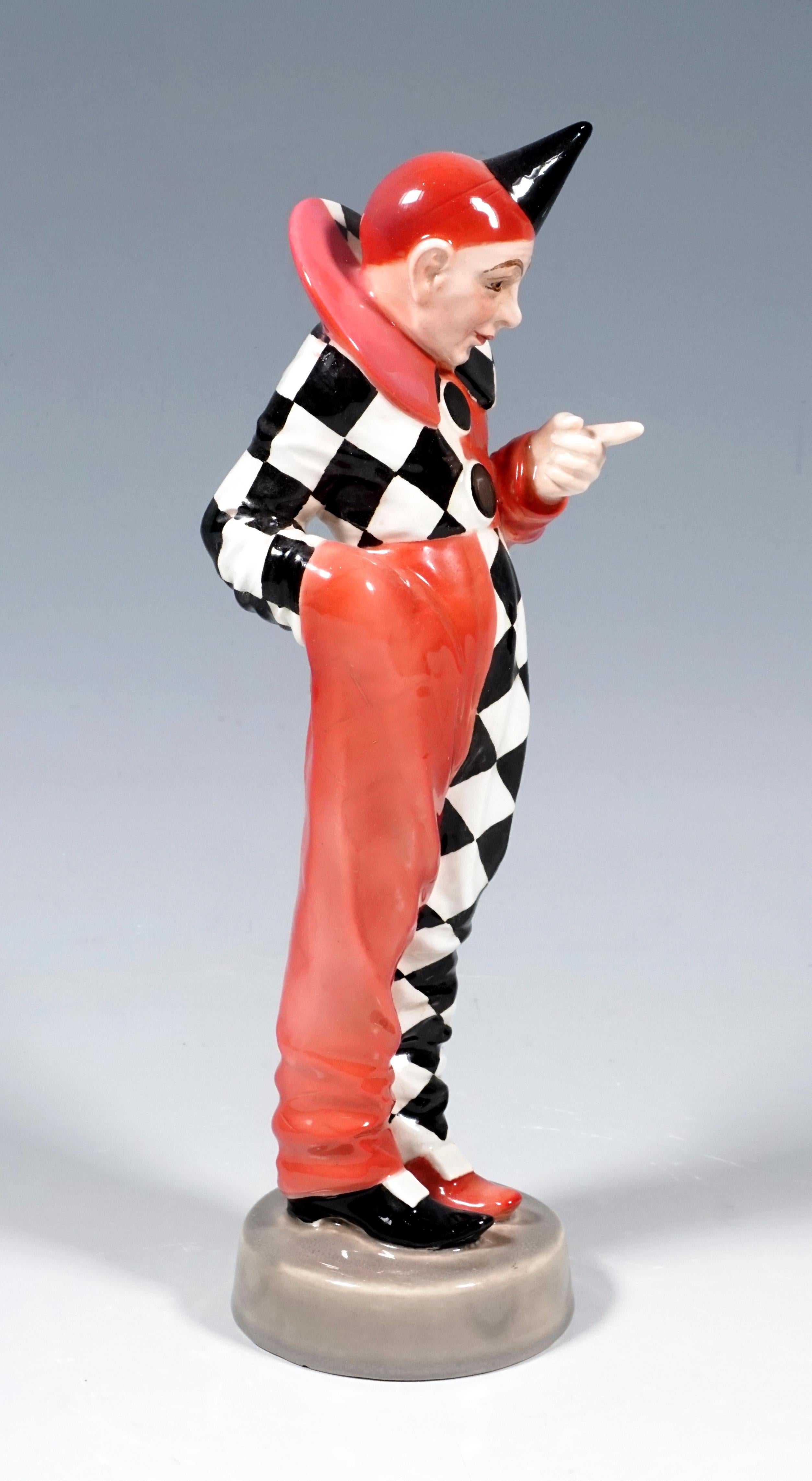 Very rare Goldscheider Art Deco ceramic figure of the 1920's:
Depiction of a standing Pierrot in a slightly bent position, his right hand in the pocket of his costume, which is put together in typical Harlequin fashion: monochrome rose-colored