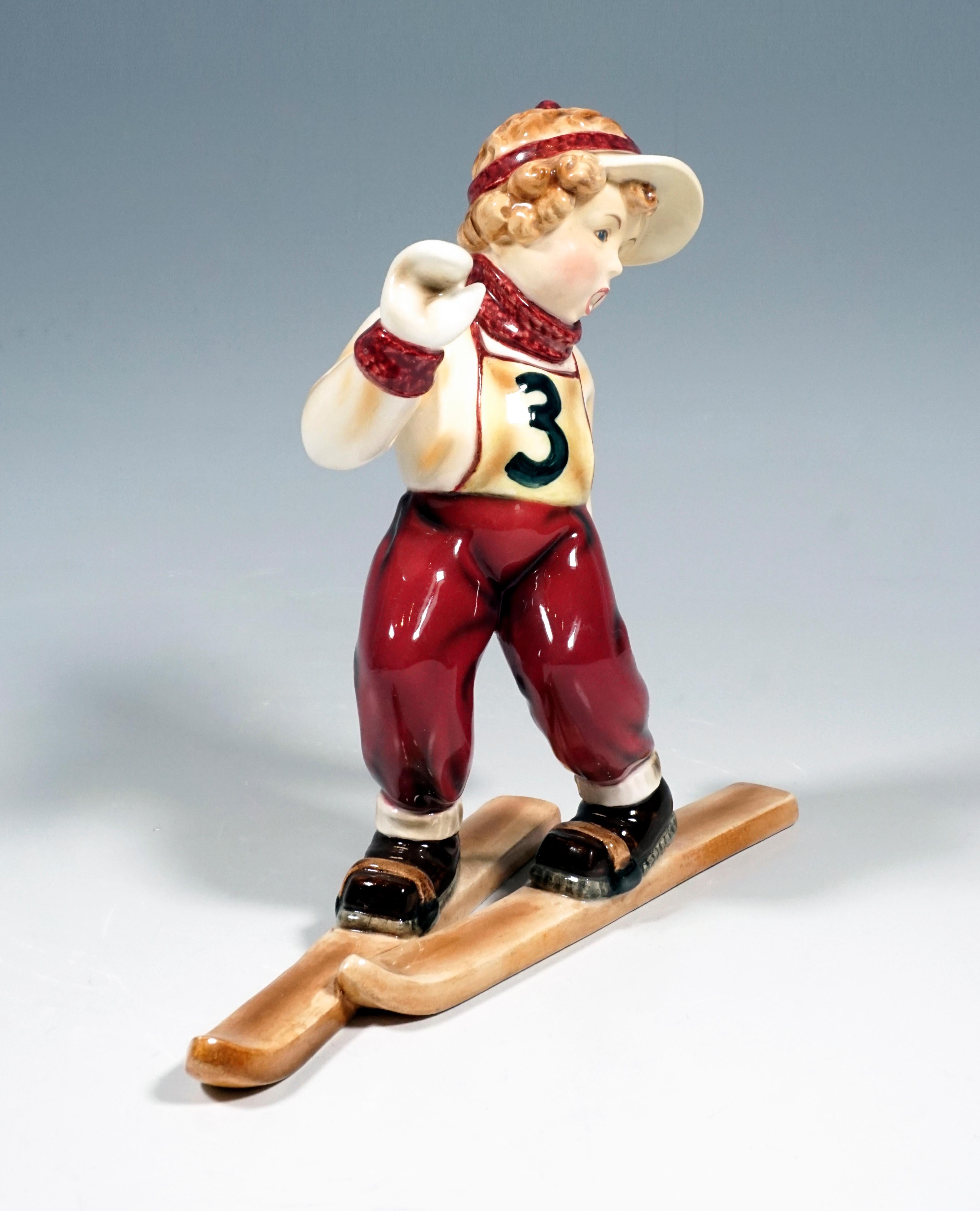 Rare Goldscheider Vienna Figurine of the 1940s.
Little girl in red ski pants with the start number '3' standing wobbly on skis.

Designed by KARL SAILER (1905 - ?), Retoucheur and modeller, has created numerous models for Goldscheider as a