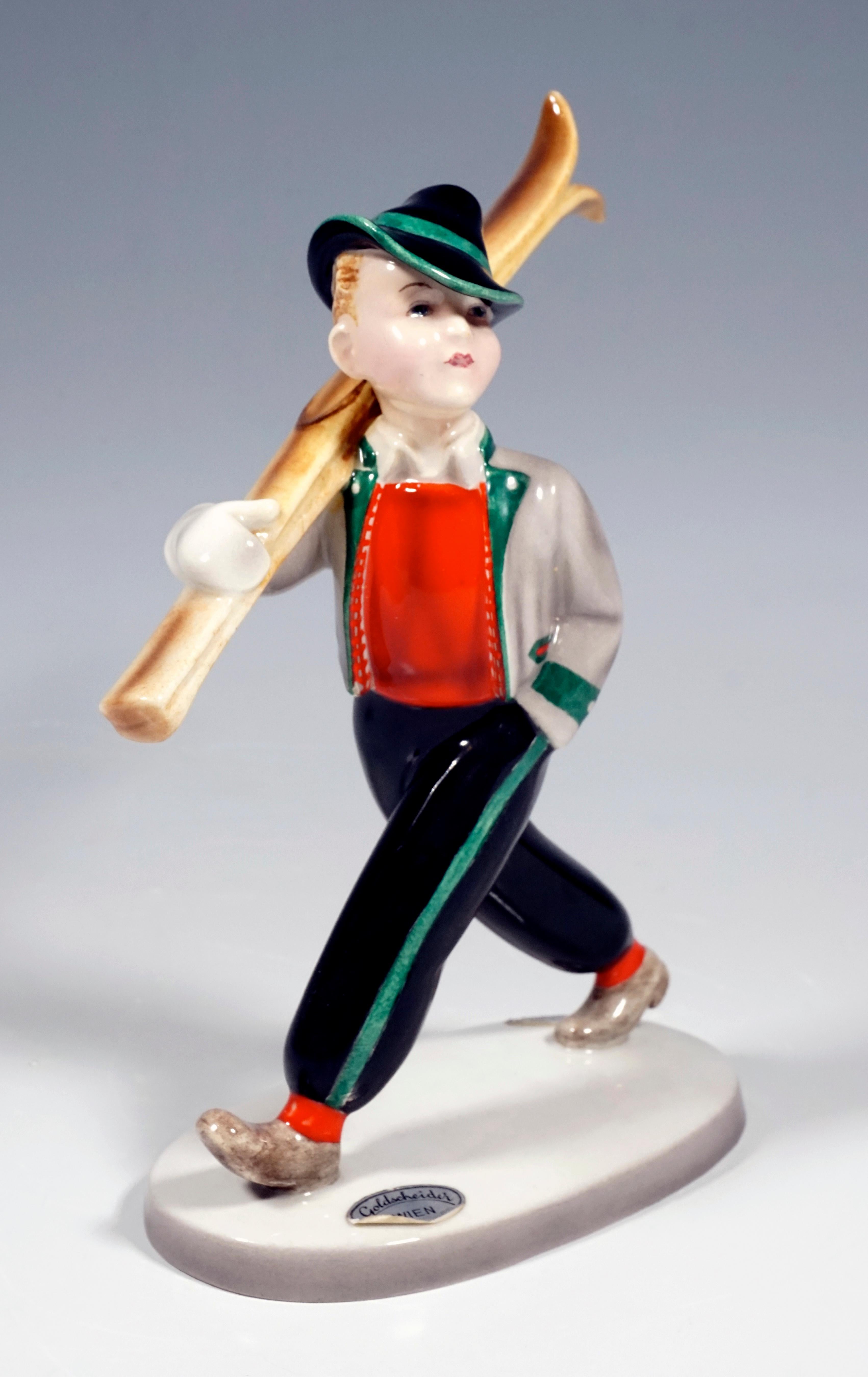 Rare Goldscheider Vienna Figurine of the 1930s.
Striding boy with shouldered skis, wearing the winter clothing customary in Tyrol in the 1930s: black trousers with cuffs and jacket in traditional style and a Tyrolean hat.
On a cream-colored oval