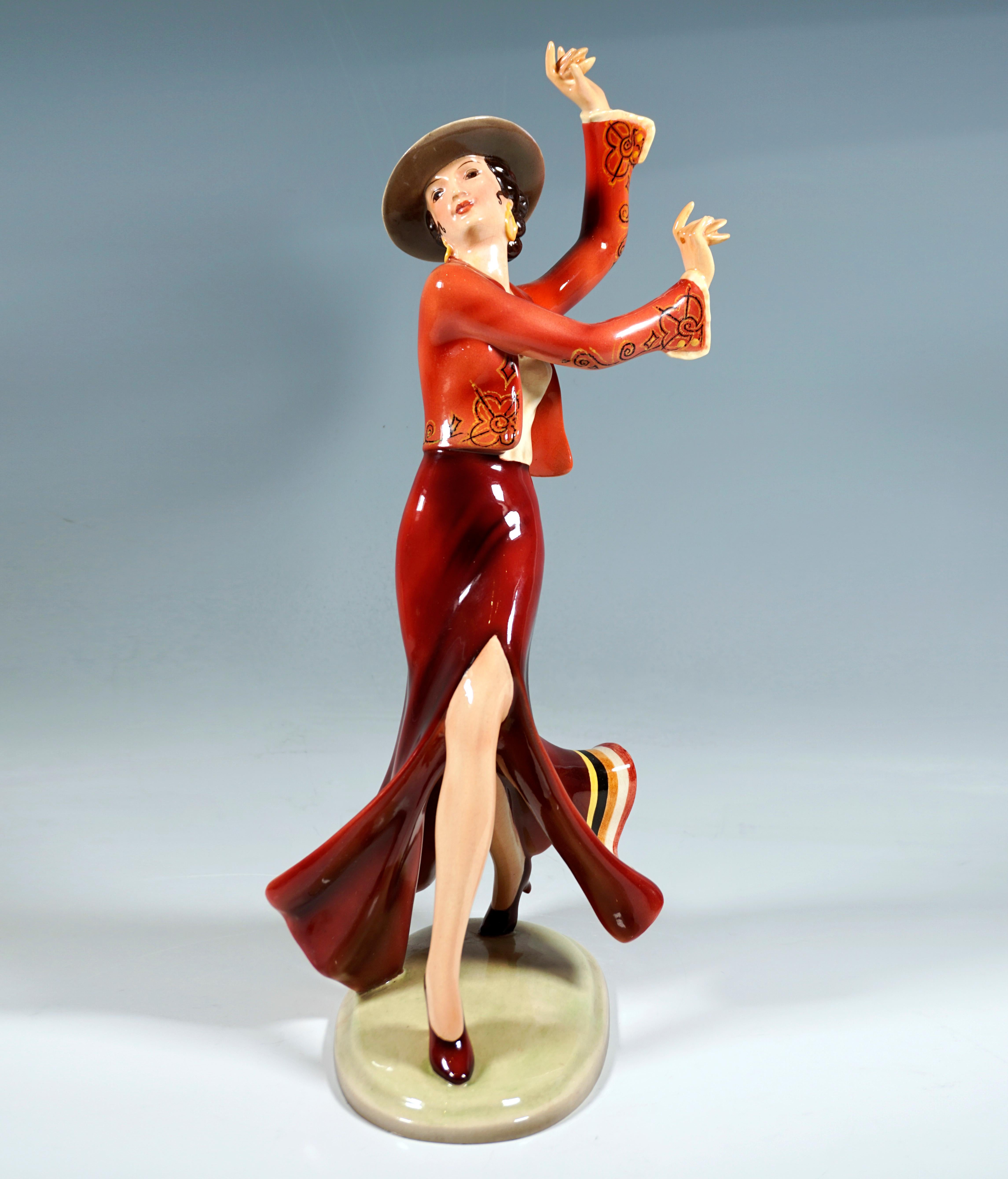 Excellent Goldscheider Vienna Art Déco Ceramic Figurine: 
Dancer in Spanish costume: long skirt with slit above the knee and embroidered bolero jacket with long sleeves, underneath a ruffled blouse, a traditional Spanish riding hat on the head,