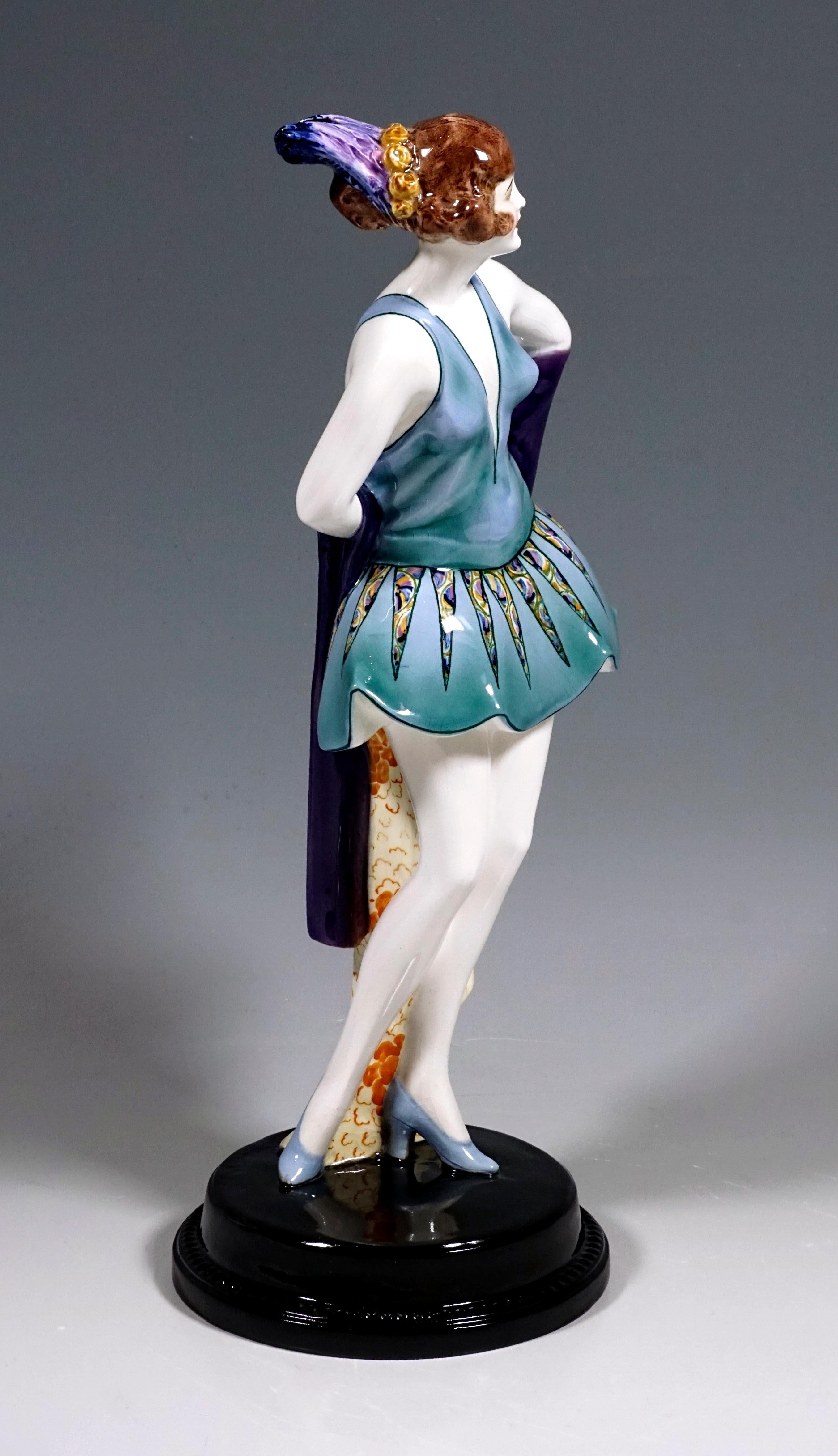 Rare figurine Art Déco en céramique Goldscheider
La danseuse porte une robe de danse bleu-vert coupée bas devant et dans le dos avec une jupe large et courte avec un motif en zigzag long et pointu, ses cheveux bruns épinglés avec un anneau de