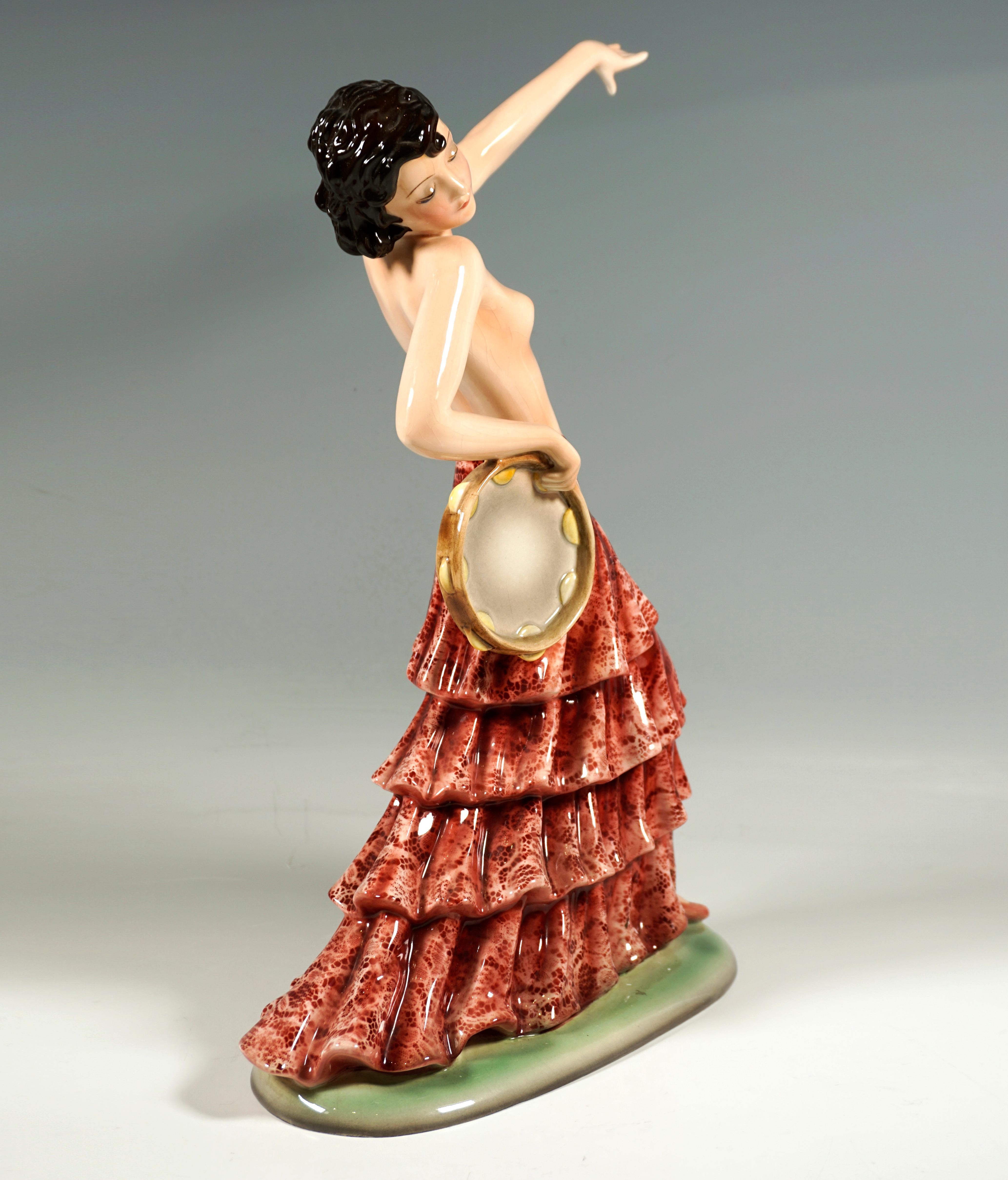 Delicate Goldscheider Art Ceramics Figurine Of The 1930s:
Flamenco dancer with chin-length hair, dressed only in a floor-length, red flounced lace skirt and shoes, turning her head to the right and looking at the ground, in a striding pose with her