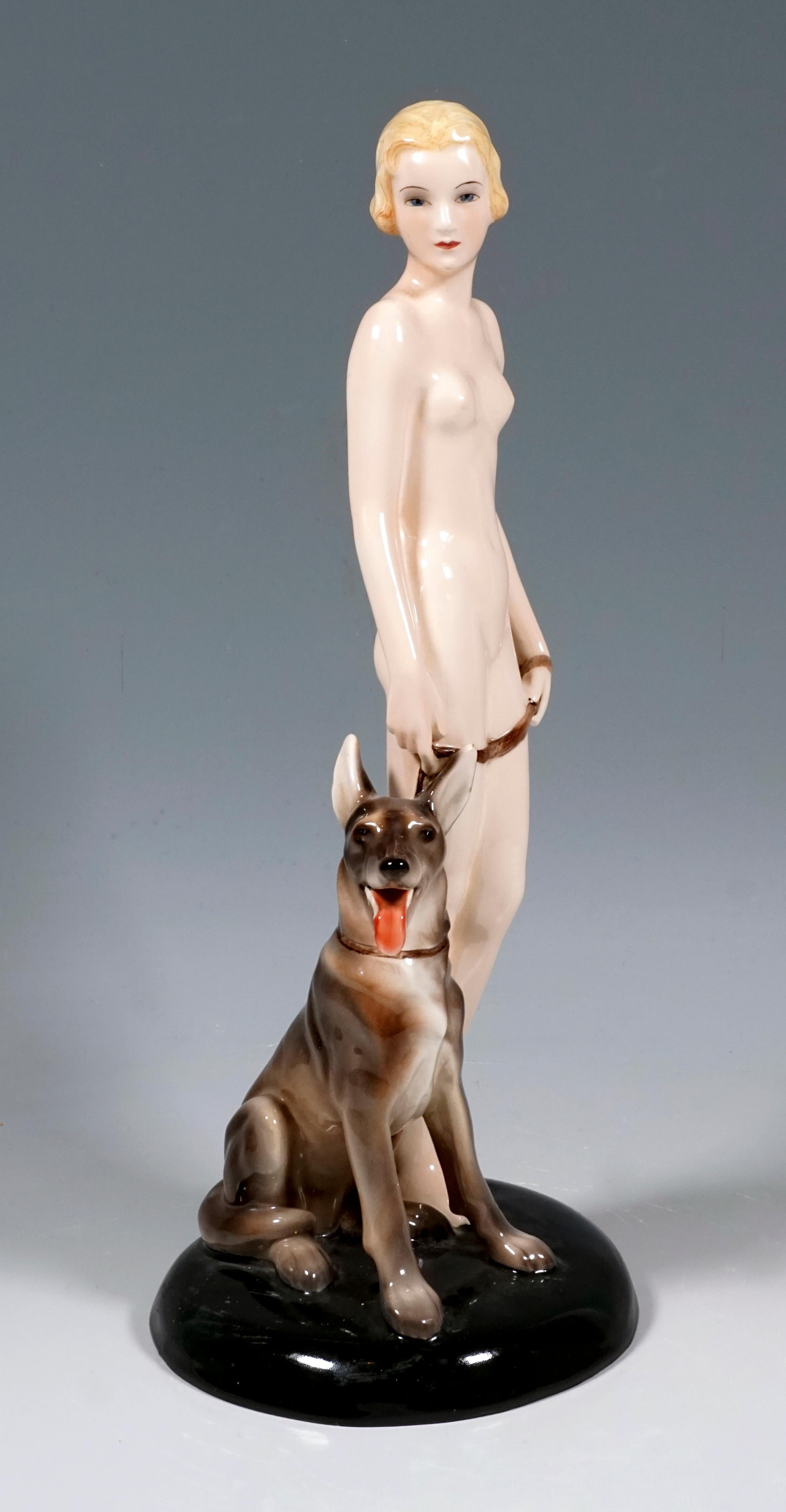 Very Rare Goldscheider Vienna Figurine of the 1930s:
Standing young, unclothed lady with chin-length blond hair, loosely holding in front of her the leash of the German shepherd sitting next to her.
On a black, slightly cambered round base,