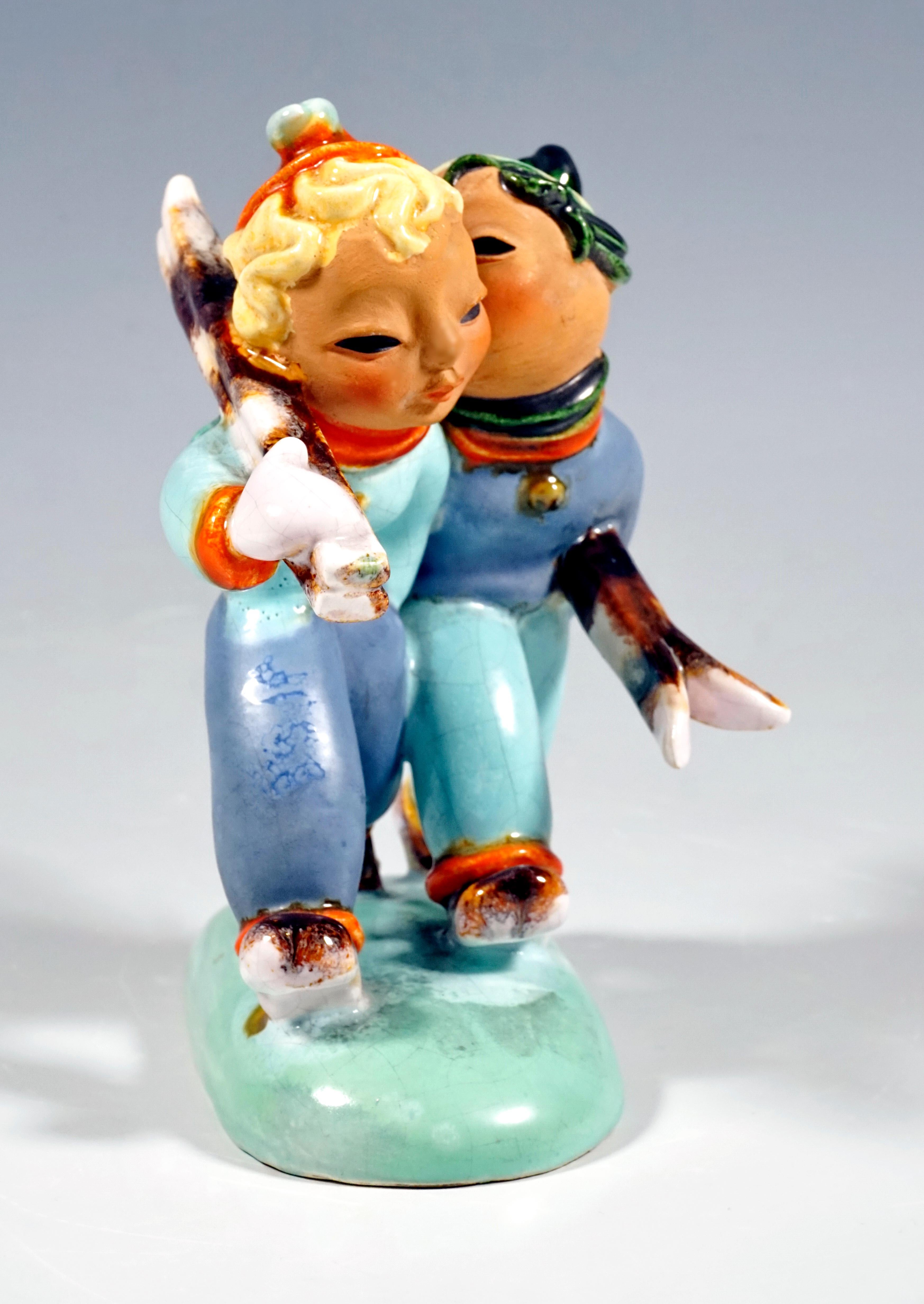 Very rare Goldscheider Vienna figurine group of the 1930s.
A striding couple of skiers in ski clothing, the lady with shoulderd skis, her kissing partner with the skis clamped under his arm; white ceramic, painted in color, partially glazed.
On a