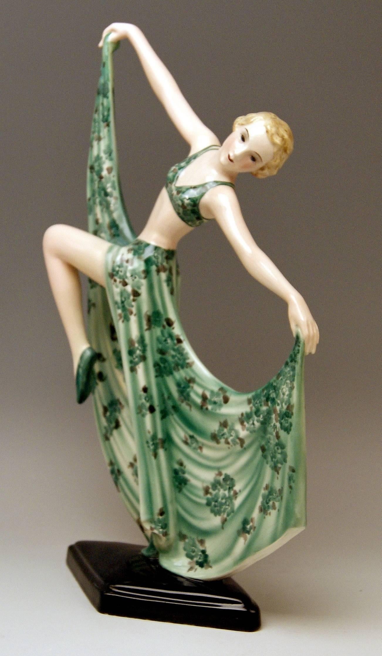 Semi-nude Art Deco lady dancer seizing corners of her skirt.
Model 7053

Size: 
height 15.2 inches (38.0 cm)
width 9.055 inches (23.0 cm)
depth 4.33 inches (11.0 cm)

Made by:
Goldscheider Vienna / manufactured circa 1936/37
Designed