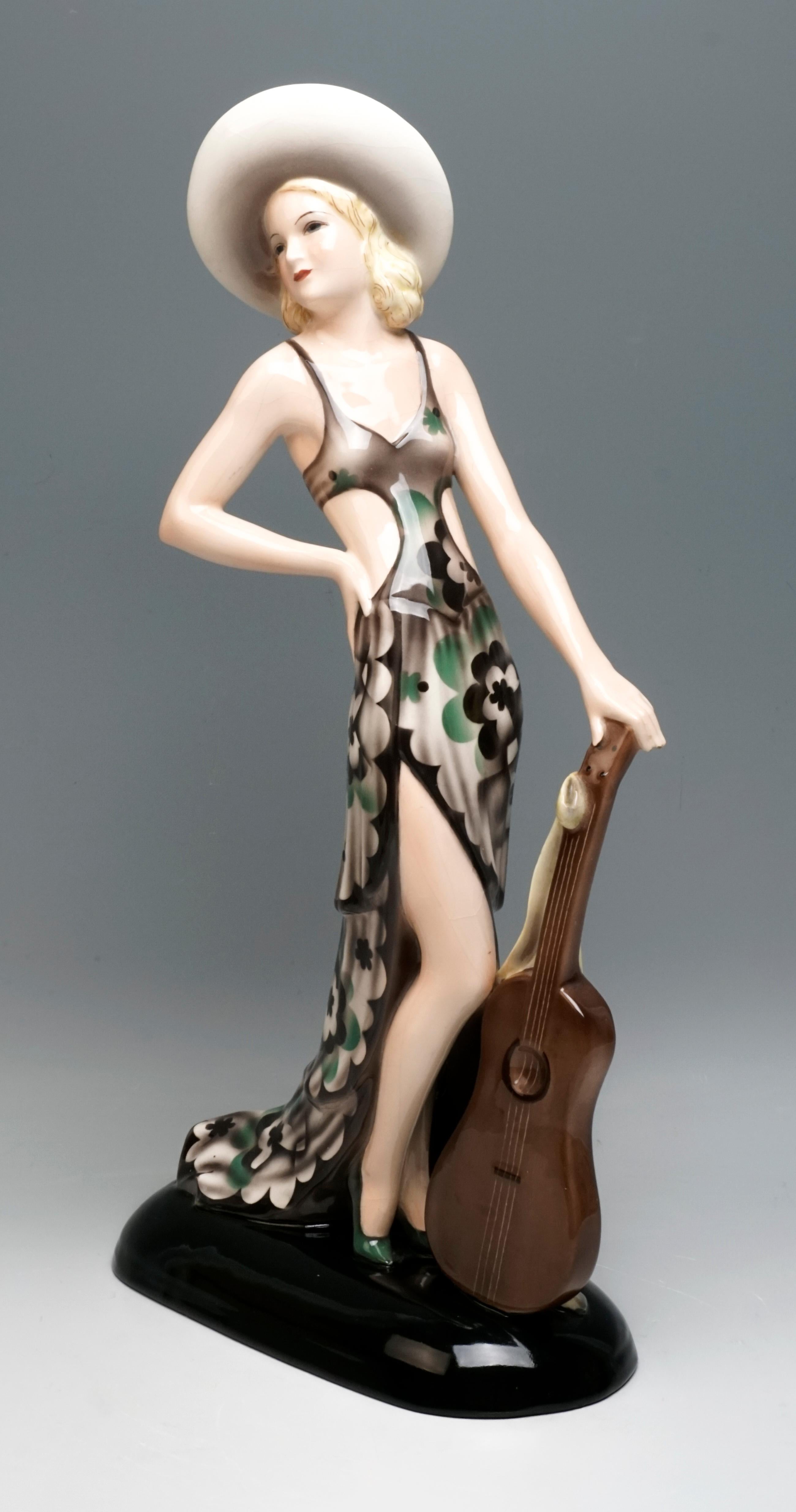 Rare Goldscheider Art Deco Ceramic Figurine.
The standing young lady is wearing a gray-green-beige dress with a bustier, an elegant, broad-brimmed, light-colored hat sits on her blond curls. Looking to the right, she lets her right, slightly raised