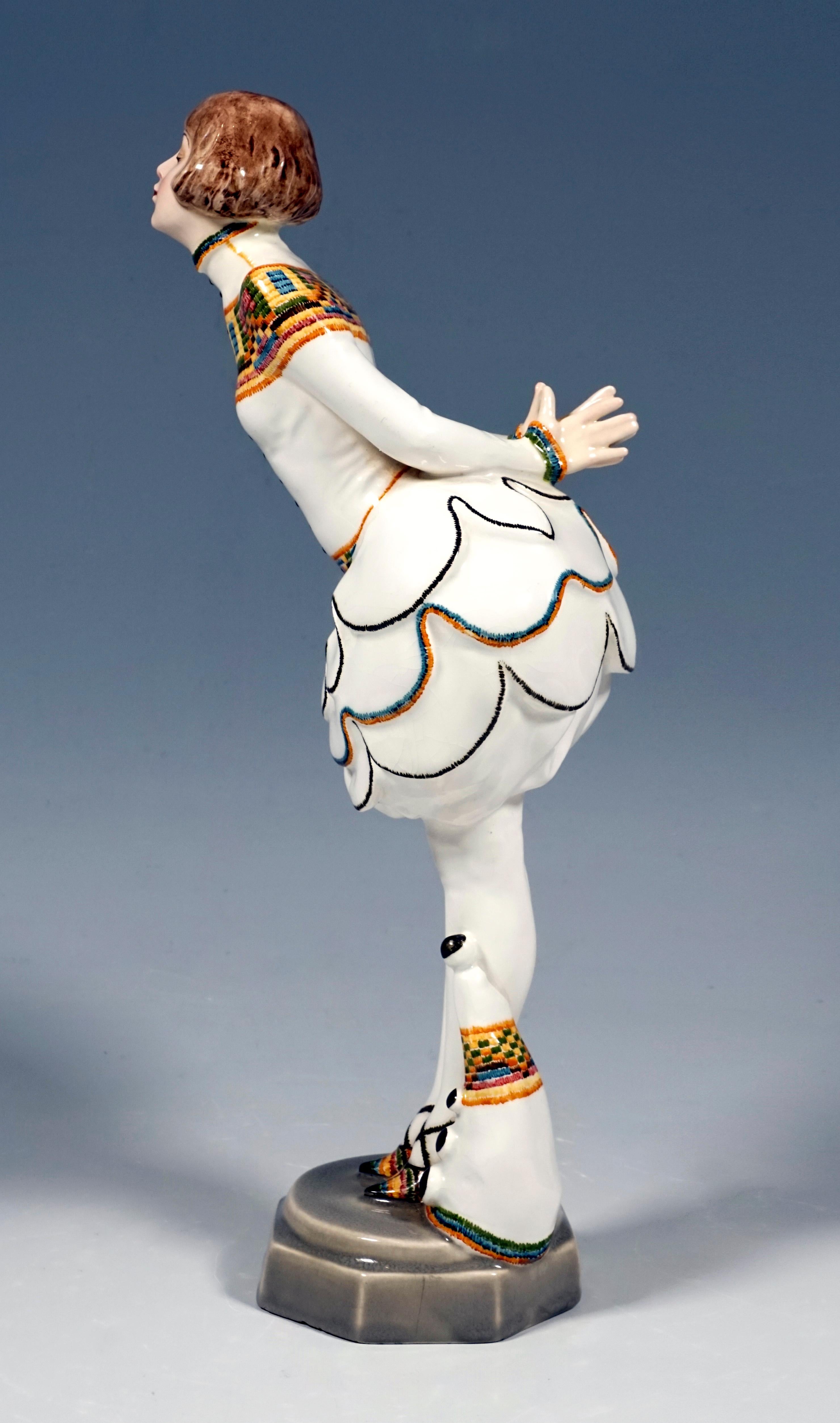 Very Rare Goldscheider Vienna Figurine of the 1920s:
Standing pierrette leaned forward and holding her hands together behind her back, in a white costume with a multi-layered, pine-cone-like balloon skirt, with partly colorfully embroidered top and