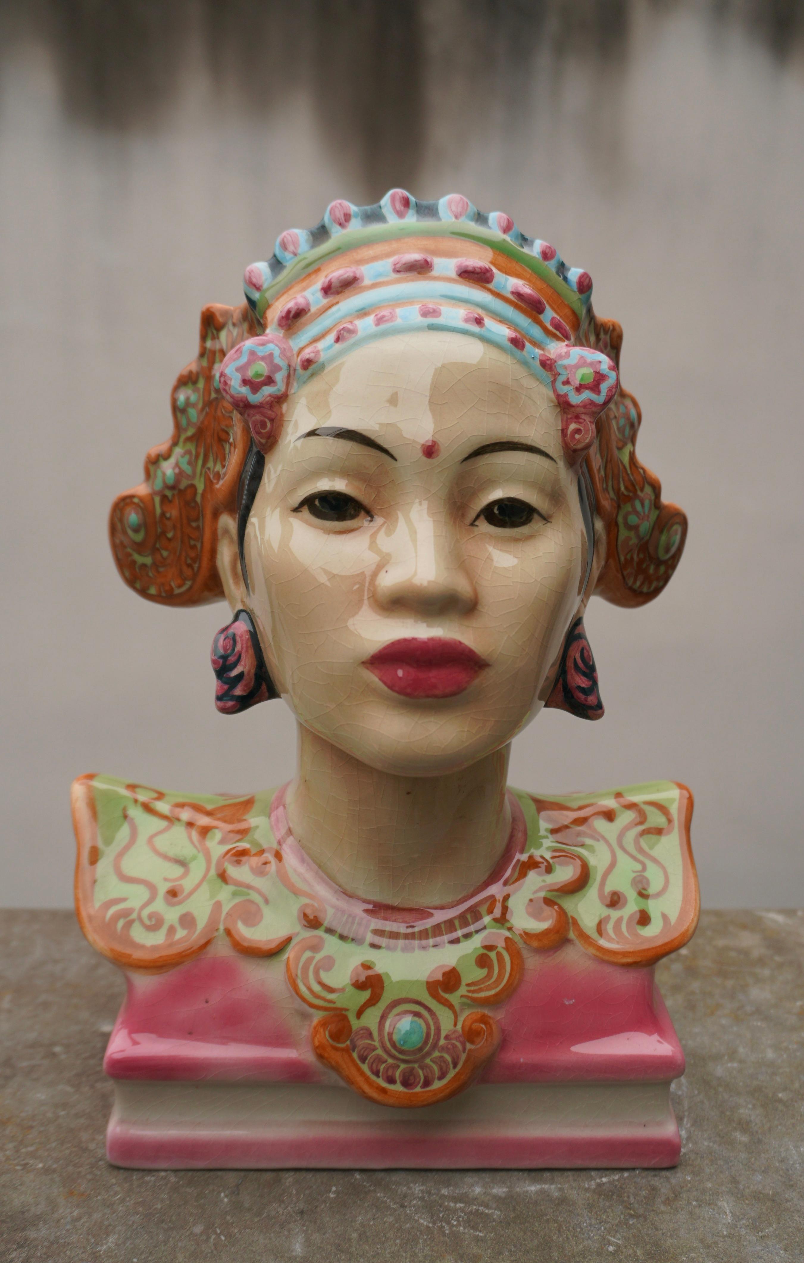 A highly Art Deco style decorative pottery bust of a Balinese dancer in striking colors by the designer Helen Liedloff, who named it 