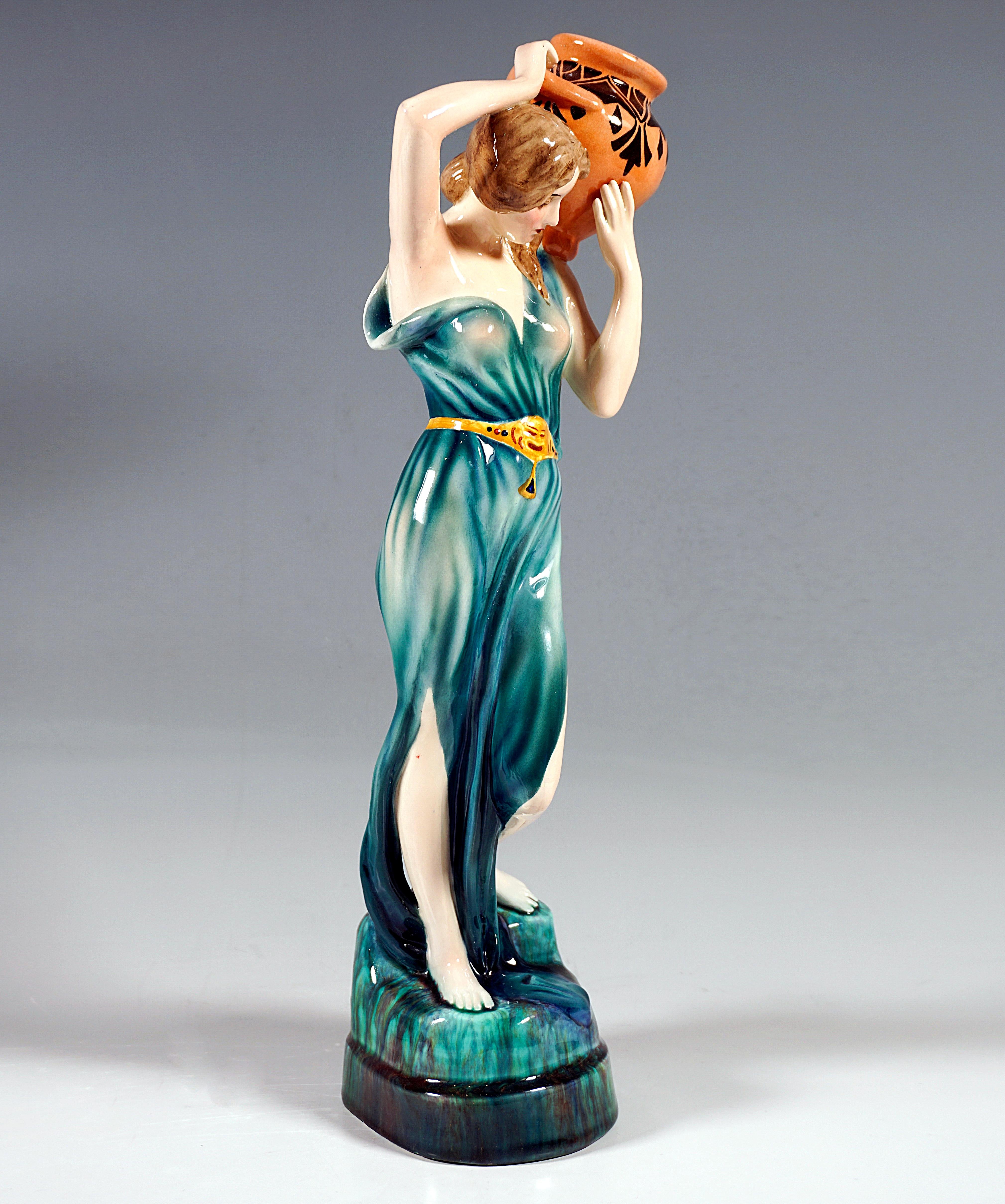 Rare Goldscheider ceramic figurine dating around 1920:
Art Déco execution of an Art Nouveau design around 1902: young lady with her hair tied at the nape of her neck and hanging forward over her shoulders, in a softly falling, transparent turquoise
