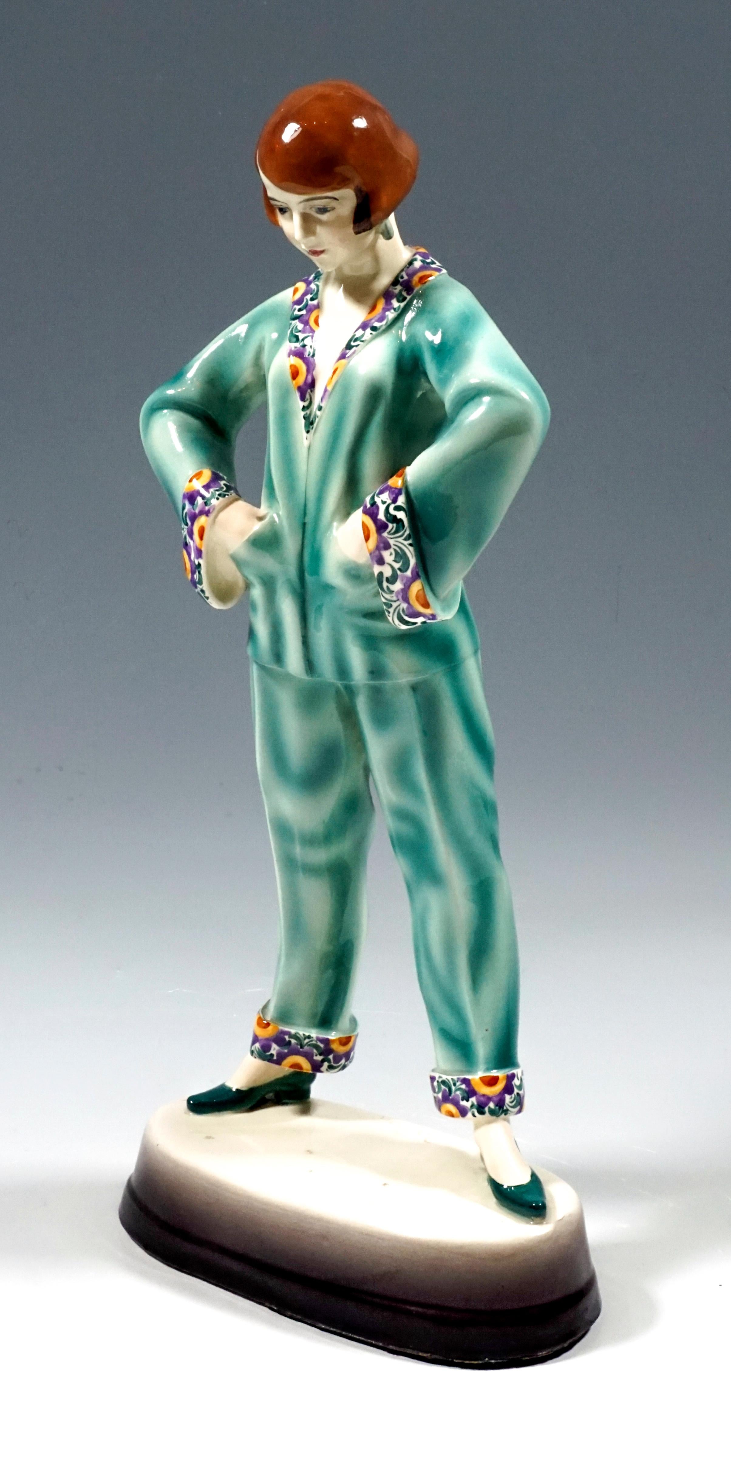Very rare Art Deco goldscheider ceramics figurine
The young lady with a brunette page-boy head, shown is the German actress Emmy Sturm (1900-1977), is wearing turquoise silk pajamas with turned-up hems in a multicolored floral pattern, standing