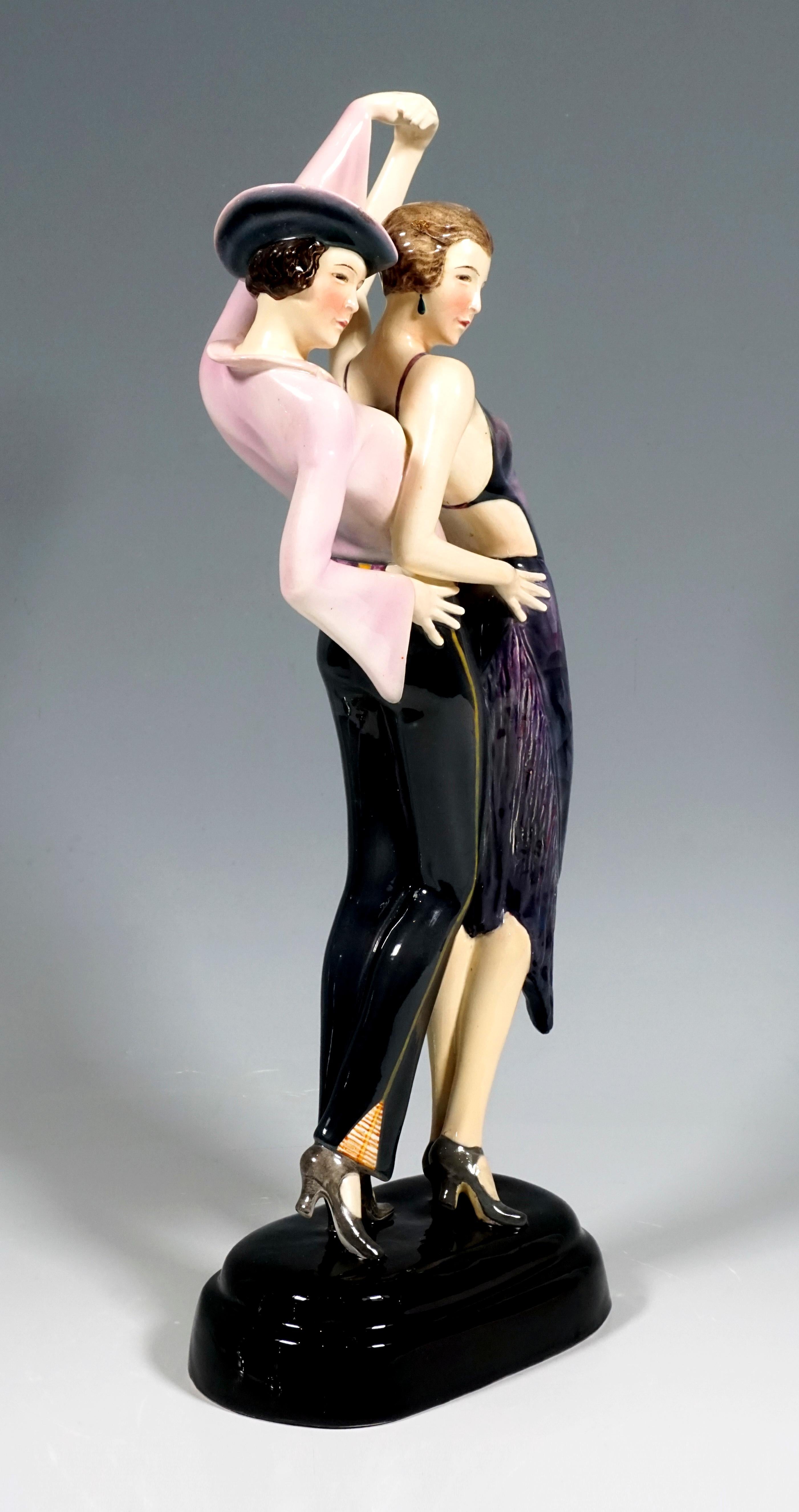 Very rare Goldscheider Ceramics Group
Two dancers posing close to each other, their upper body slightly bent back, their right hands on their hips, holding each other's left, raised hands. The front lady in a tight dance dress with a fringed hem,