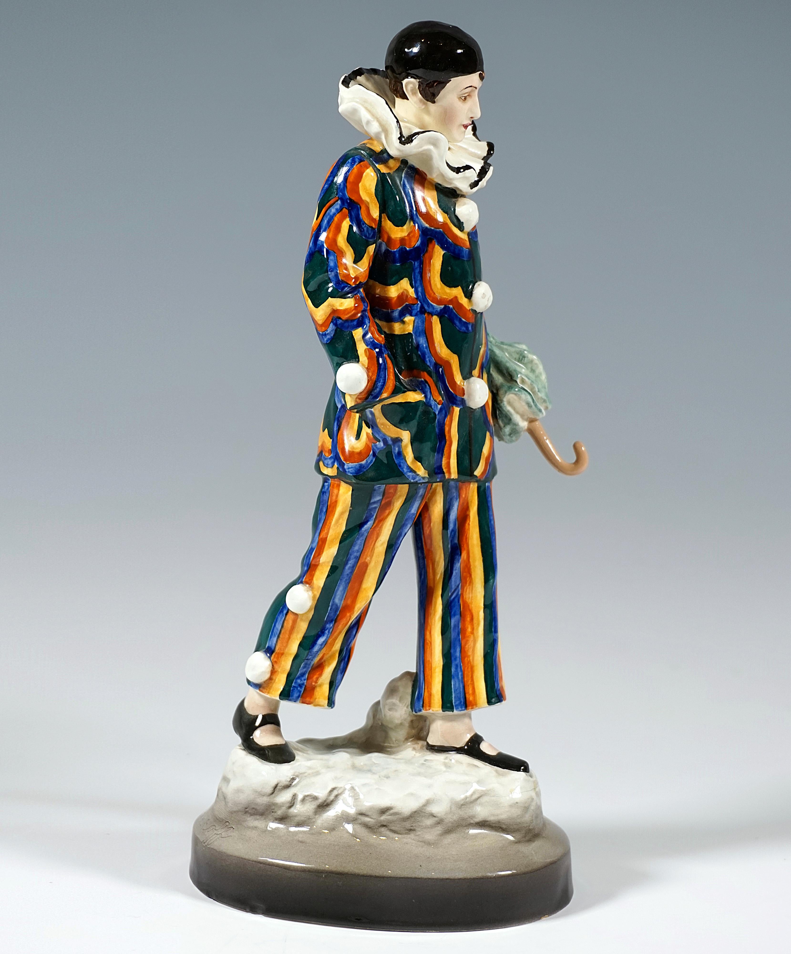 Exceptional Goldscheider Figurine of the 1920s after an Art Nouveau Design:Depiction of a harlequin striding lost in thought in a costume with colorful striped pants and wide jacket decorated with large stylized floral decoration with white tassel