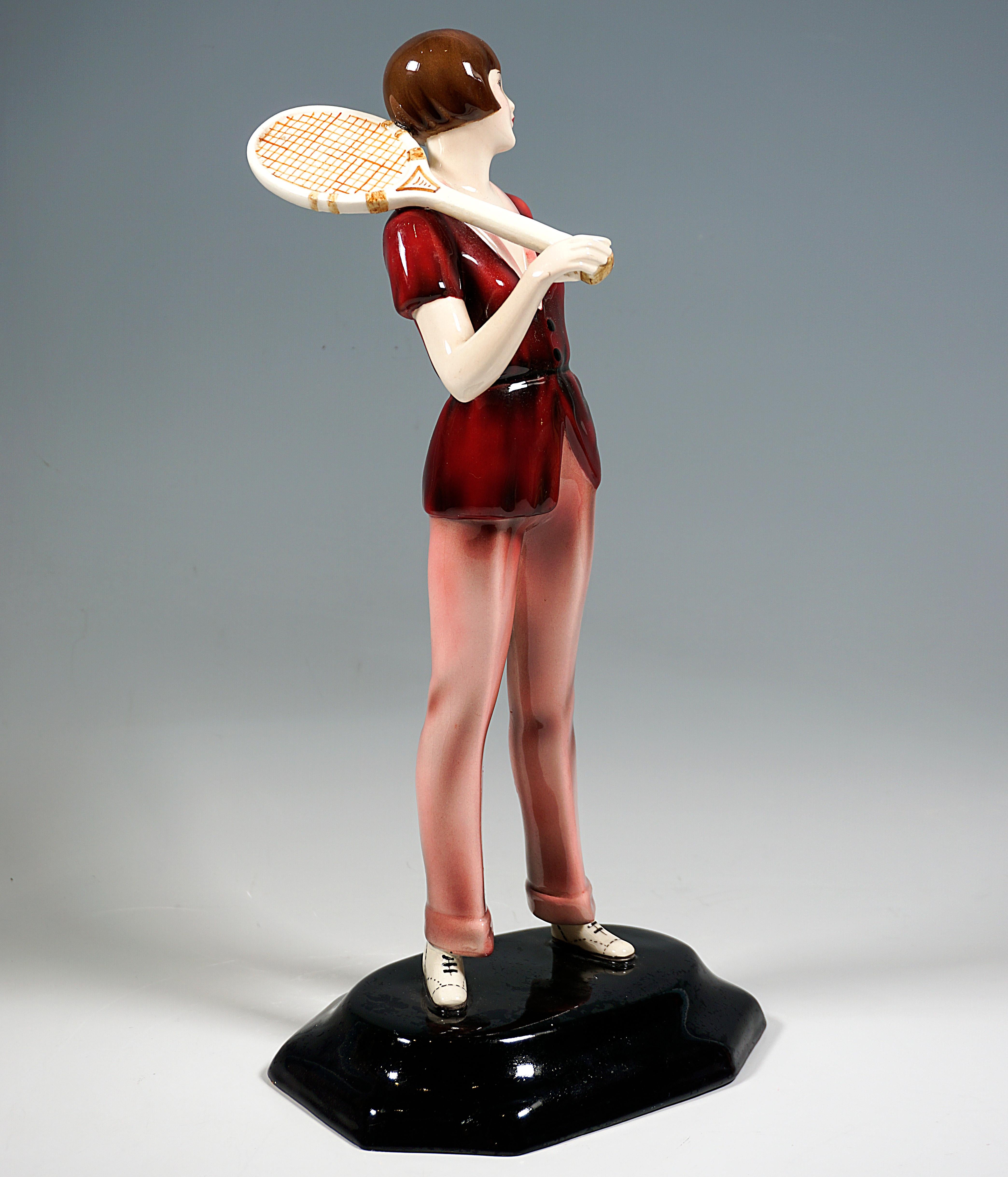 Very Rare Goldscheider Ceramic Art Figure from around 1930:
Standing young lady with a brunette bobbed haircut in elegant sportswear: comfortable, short-sleeved waistcoat with a low cut at the front, long pants with pressed creases and turn-ups,