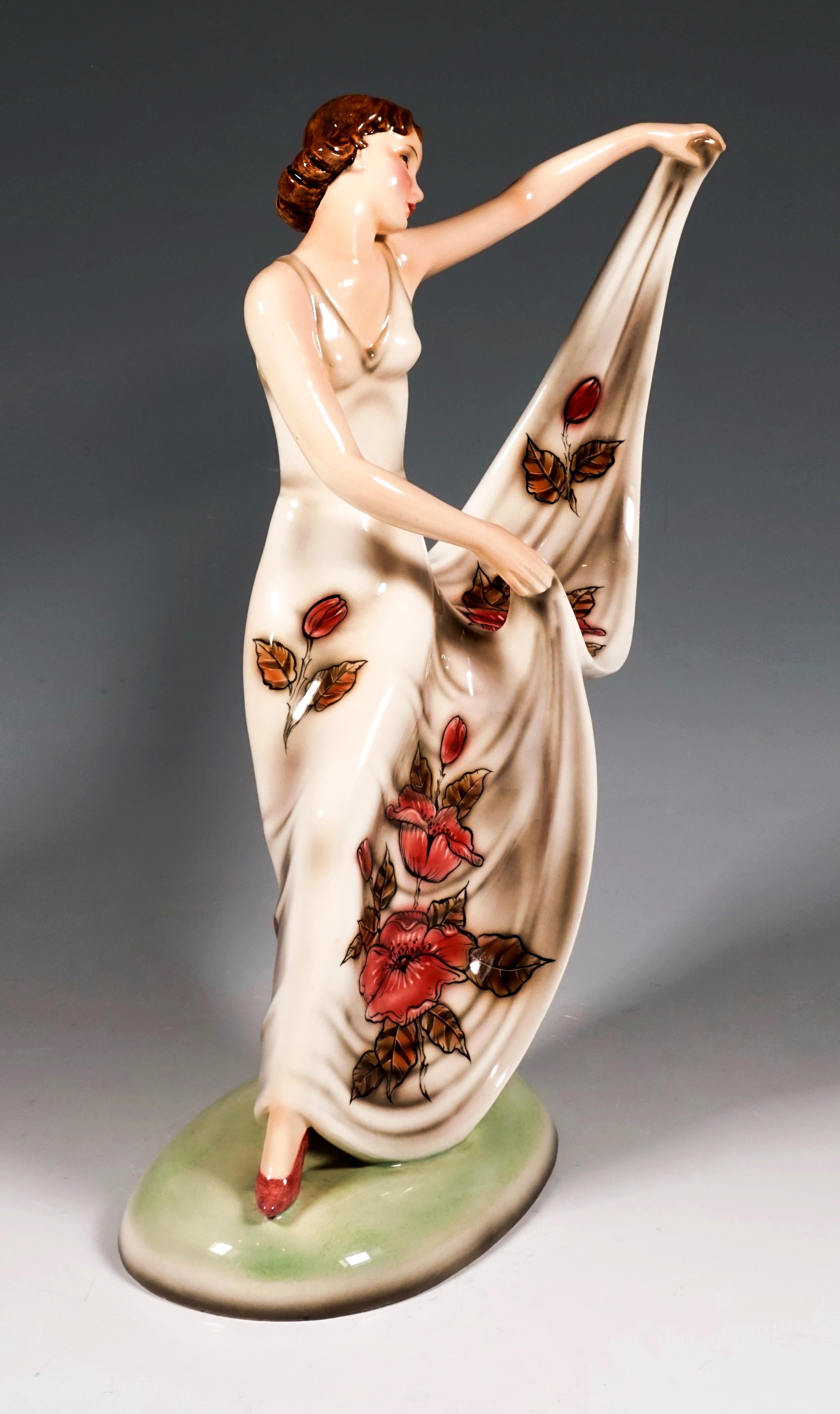Graceful, striding dancer with torso turned to the left and head tilted slightly to the side, holding the hem of her floor-length, wide, cream-colored dance dress with rose-colored floral decoration up to the side.
On a slightly cambered oval base