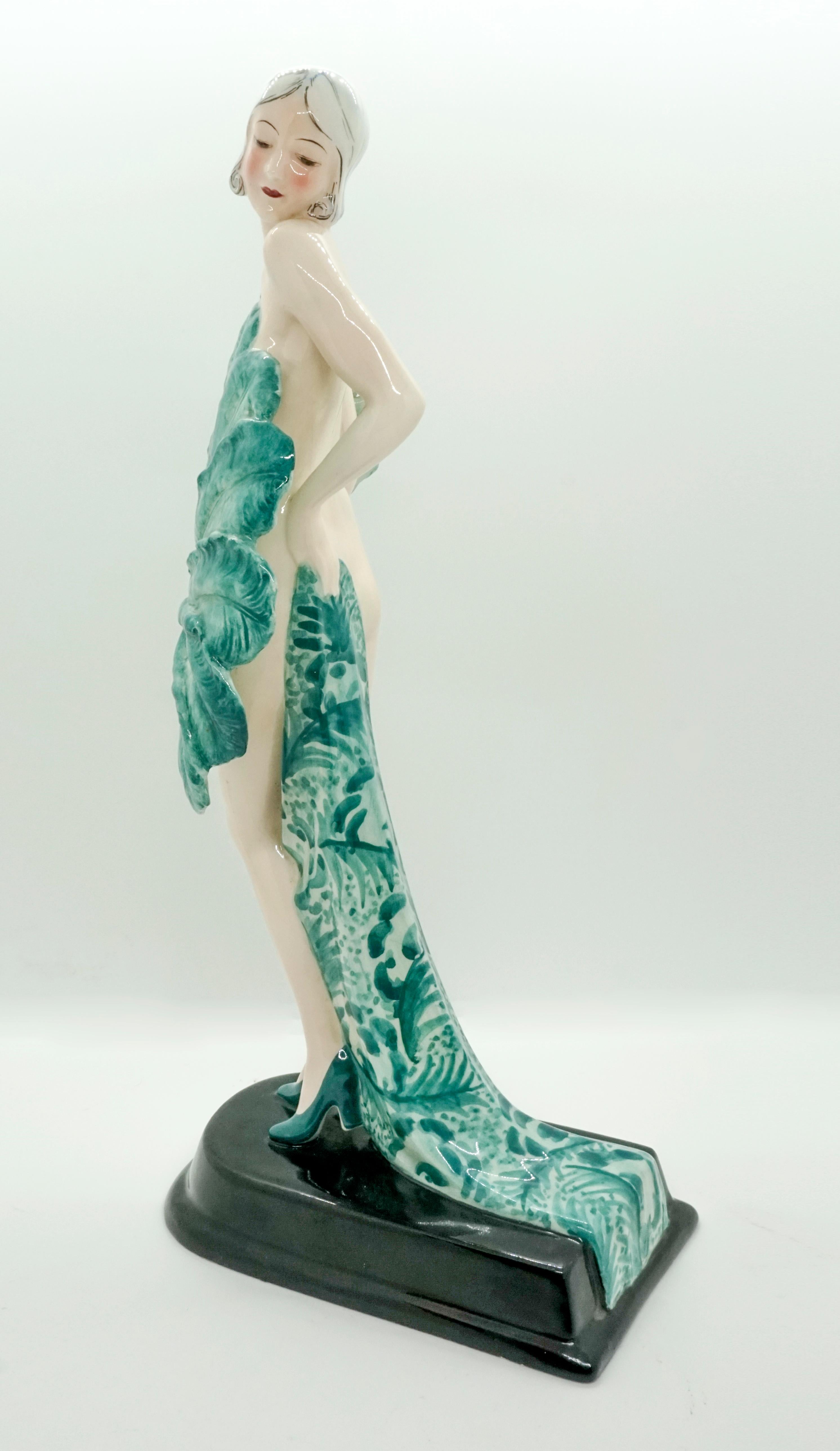 Rare Goldscheider ceramics of the 1930s

The standing young variety dancer is only dressed in high heels. Looking to the left over her shoulder, she holds a large fan in her right hand in front of herself, in her left she holds a long cloth to her