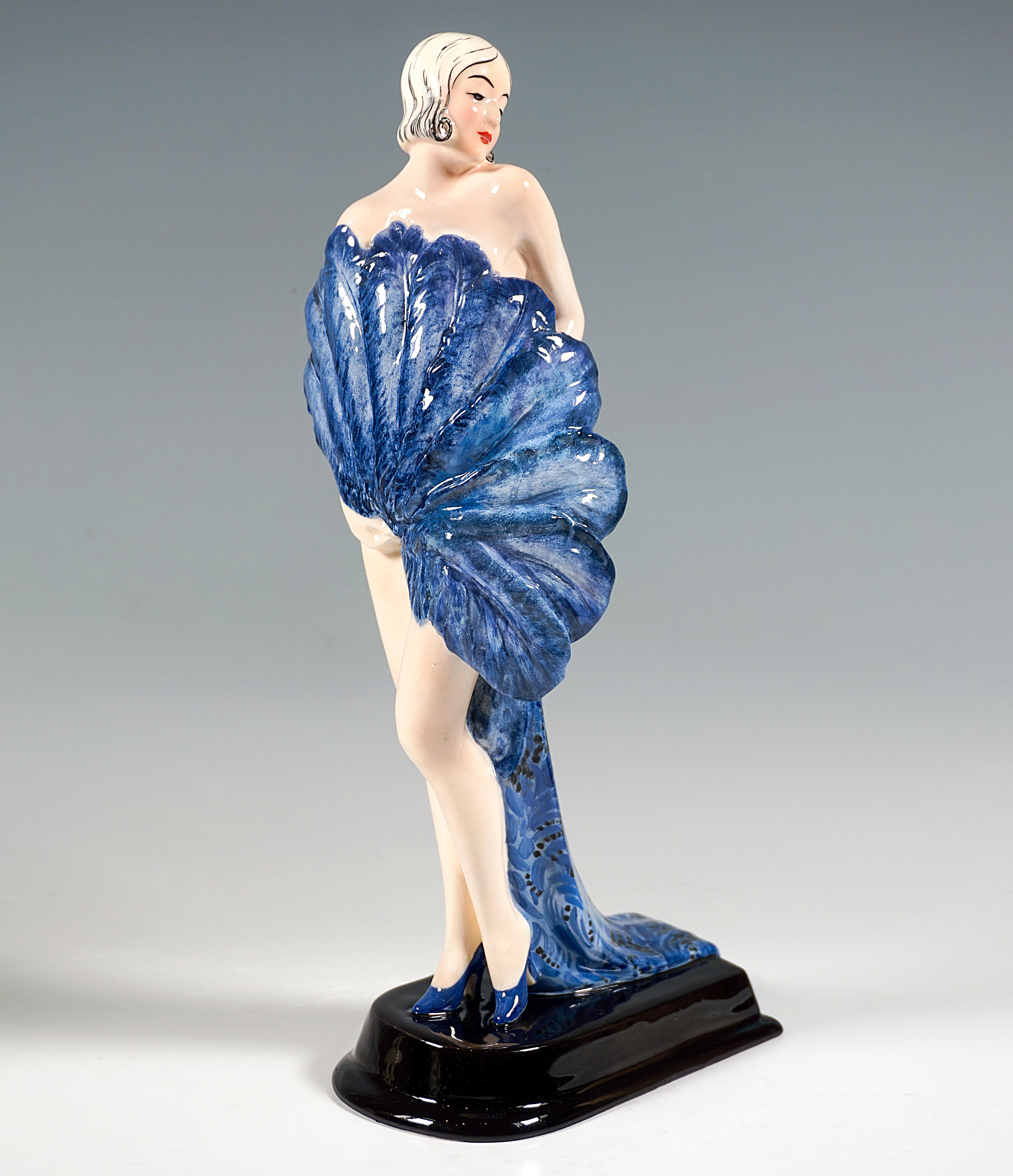 Rare Goldscheider Art Ceramics From The Early 1930s:
Standing, young variety dancer, wearing only high heels, looking to the left over her shoulder, holding a large fan in her right hand in front of her and covering her nakedness, in her left hand