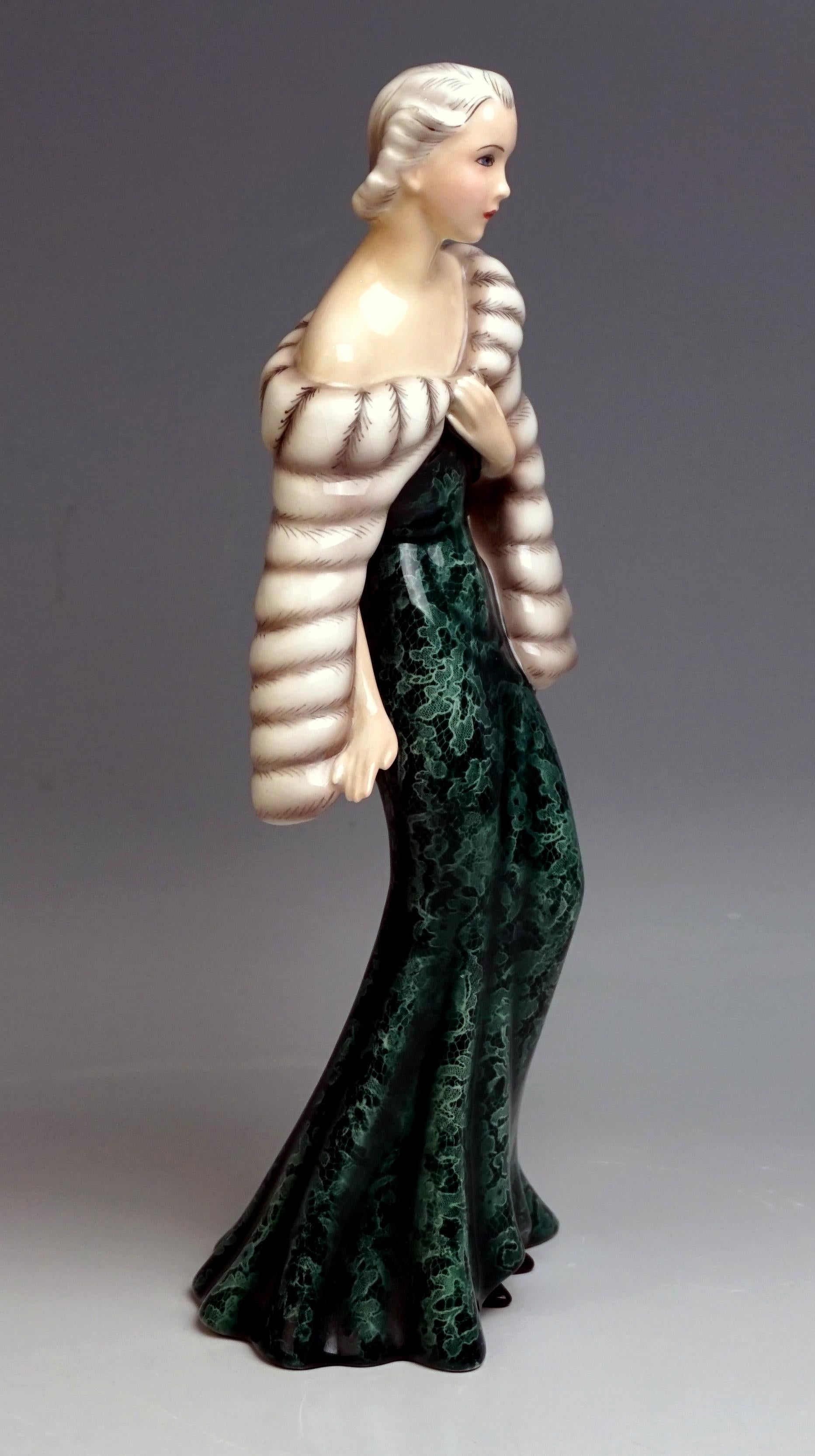 Elegant lady in evening dress and fur cape

Manufactory: Goldscheider Vienna / Austria
Dating: circa 1937-1938
Technique: hand crafted ceramics, finest hand painting, glossy finish

Designer:
Claire/Klára Herczeg/Weiss (1906-1997)
The model