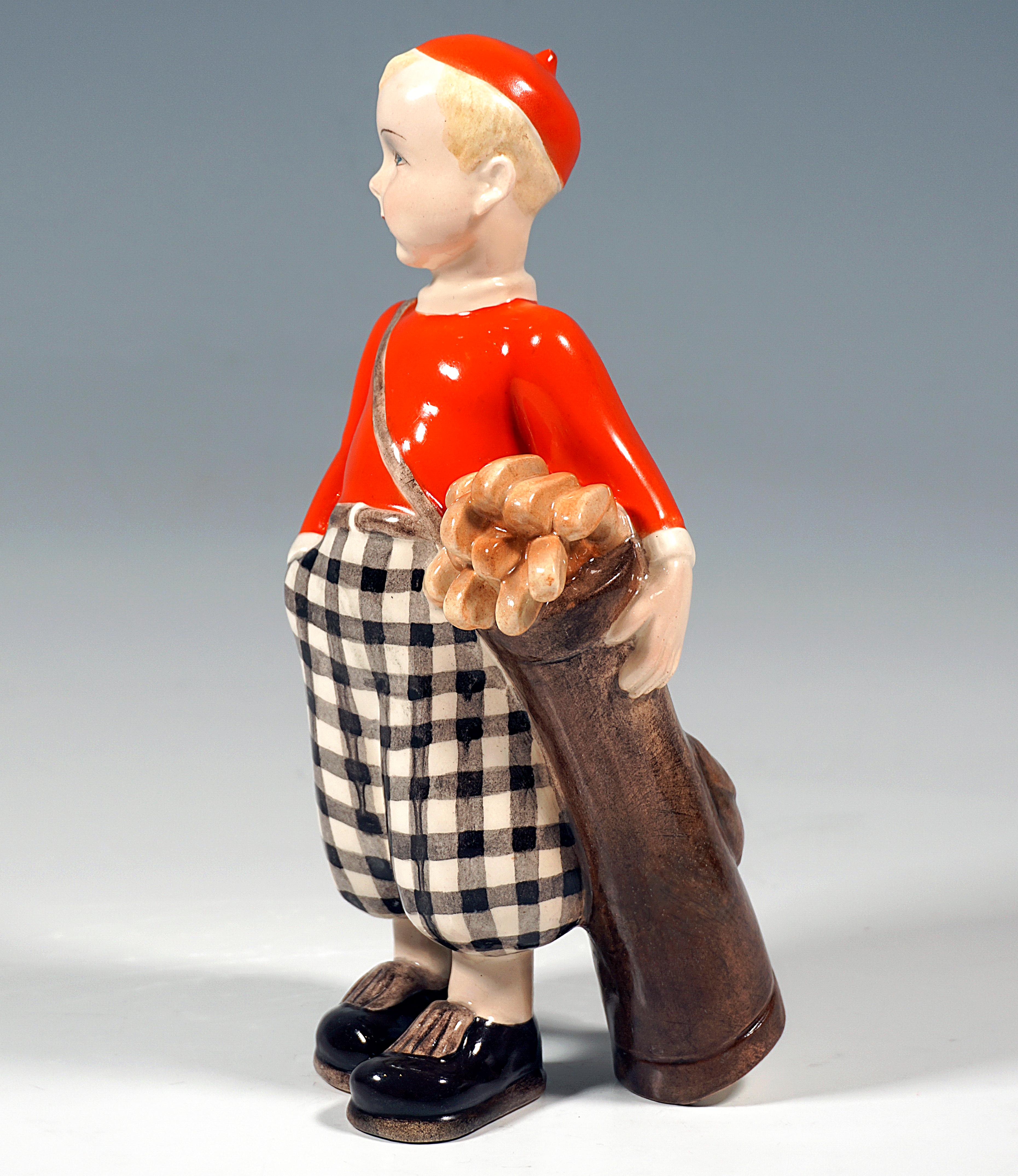 Boy with red cap, red jumper and checked harem pants standing, facing right, right hand in trouser pocket, carrying golf bag full of clubs and clasping it with his left hand.

Designer:
Claire/Klára Herczeg/Weiss (1906 - 1997)
Sculptor,