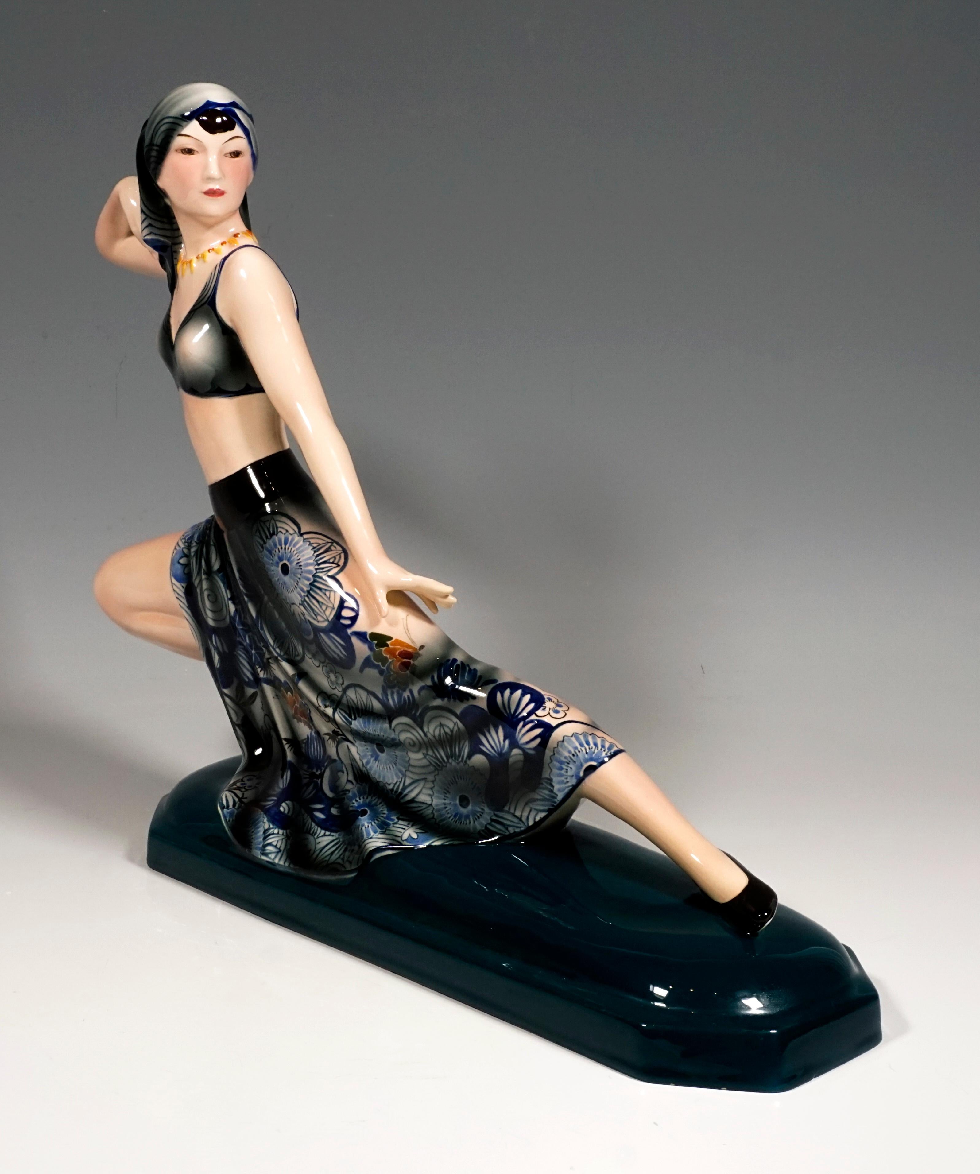 Rare Goldscheider Figurine of the 1930s

The dancer has her hair covered with a headscarf and is wearing a bustier and a long, wide skirt with blue flowers and colorful butterflies. With her head turned to the left, her right arm raised behind her