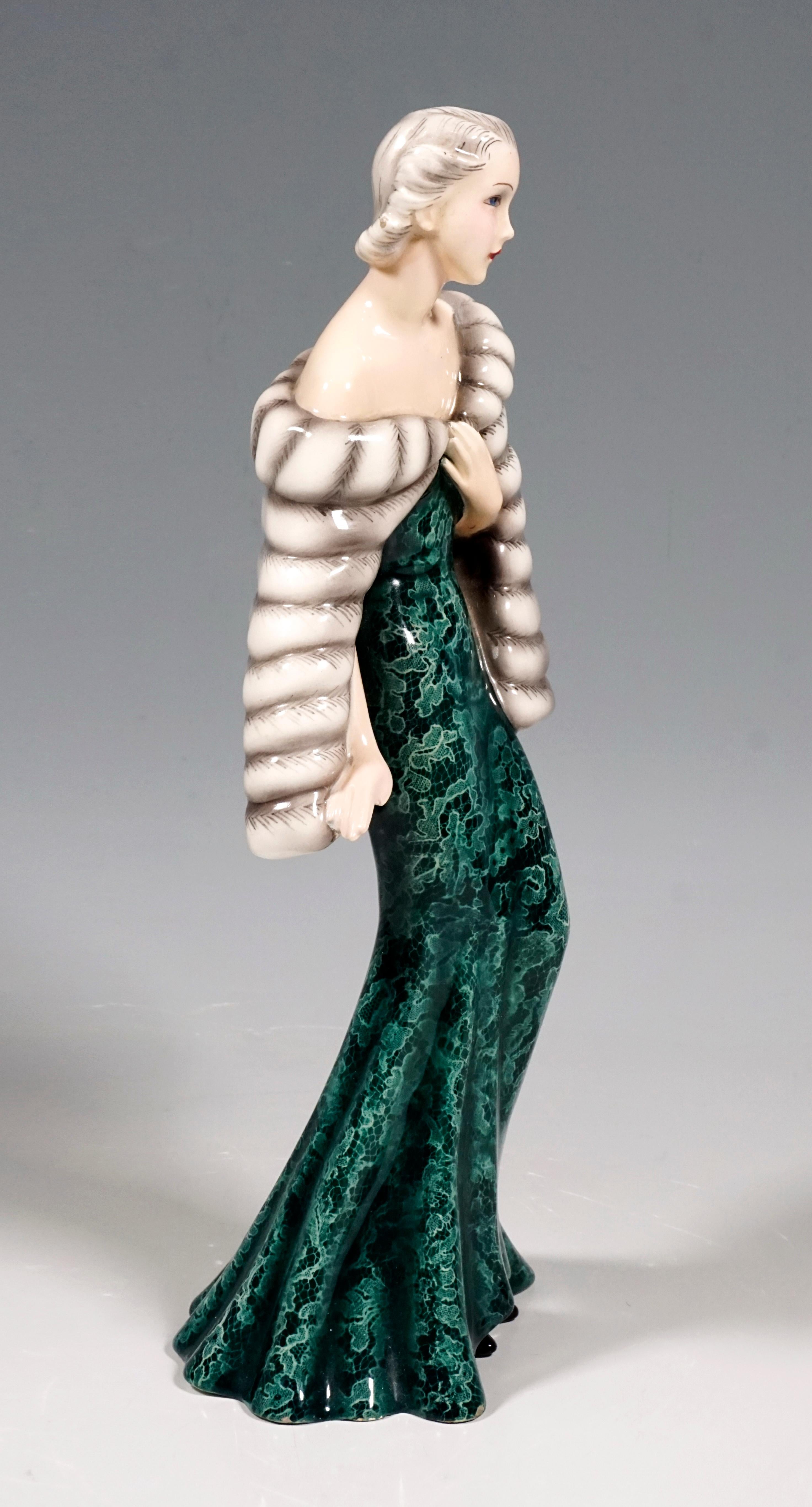 Depiction of an elegant lady in a long, tight-fitting green dress with a white lace pattern and a wide skirt part. Over it she wears a white fur cape, her hair pinned up and matched to the color of the fur, under the robe in front her pointed black