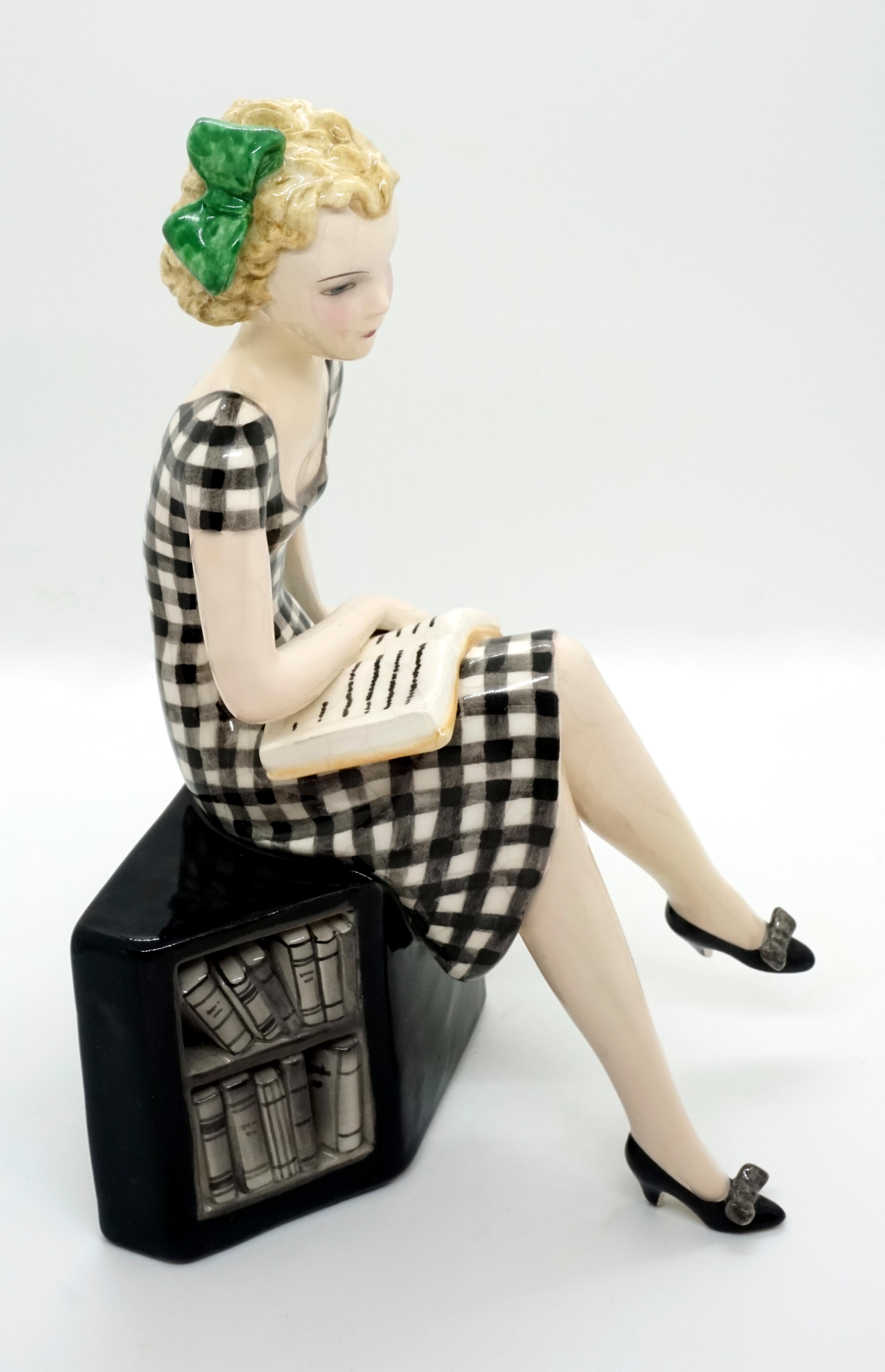 Hand-Painted Goldscheider Vienna Girl with Book Sitting on a Bookshelf by Dakon, circa 1935