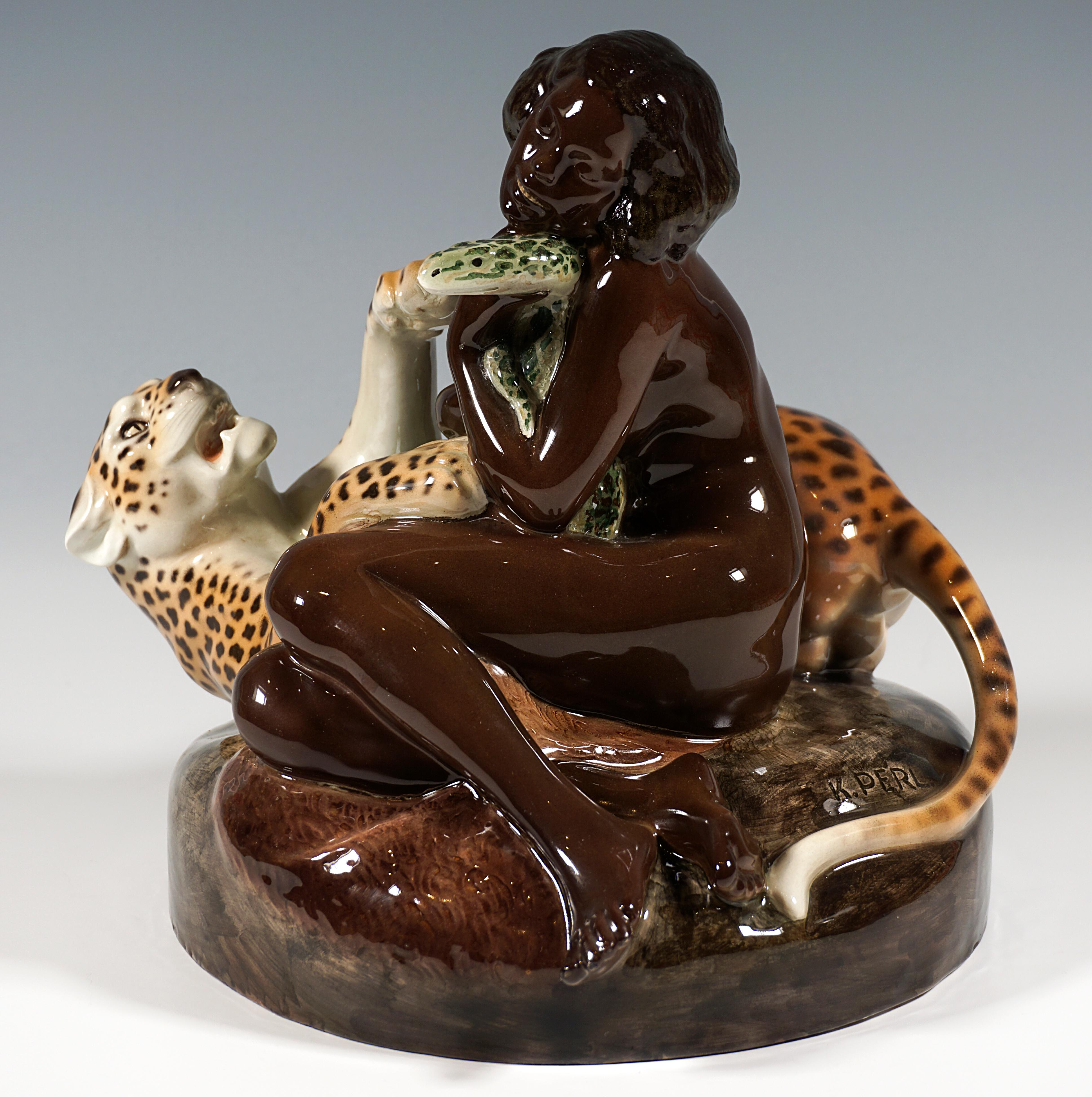 Rare and exceptional Goldscheider Art Déco ceramic group of the 1920s:
Unclothed woman sitting sideways on a rock, leaning against a leopard, which playfully winds around her on the ground and turns towards her, a large twisted snake lying on the