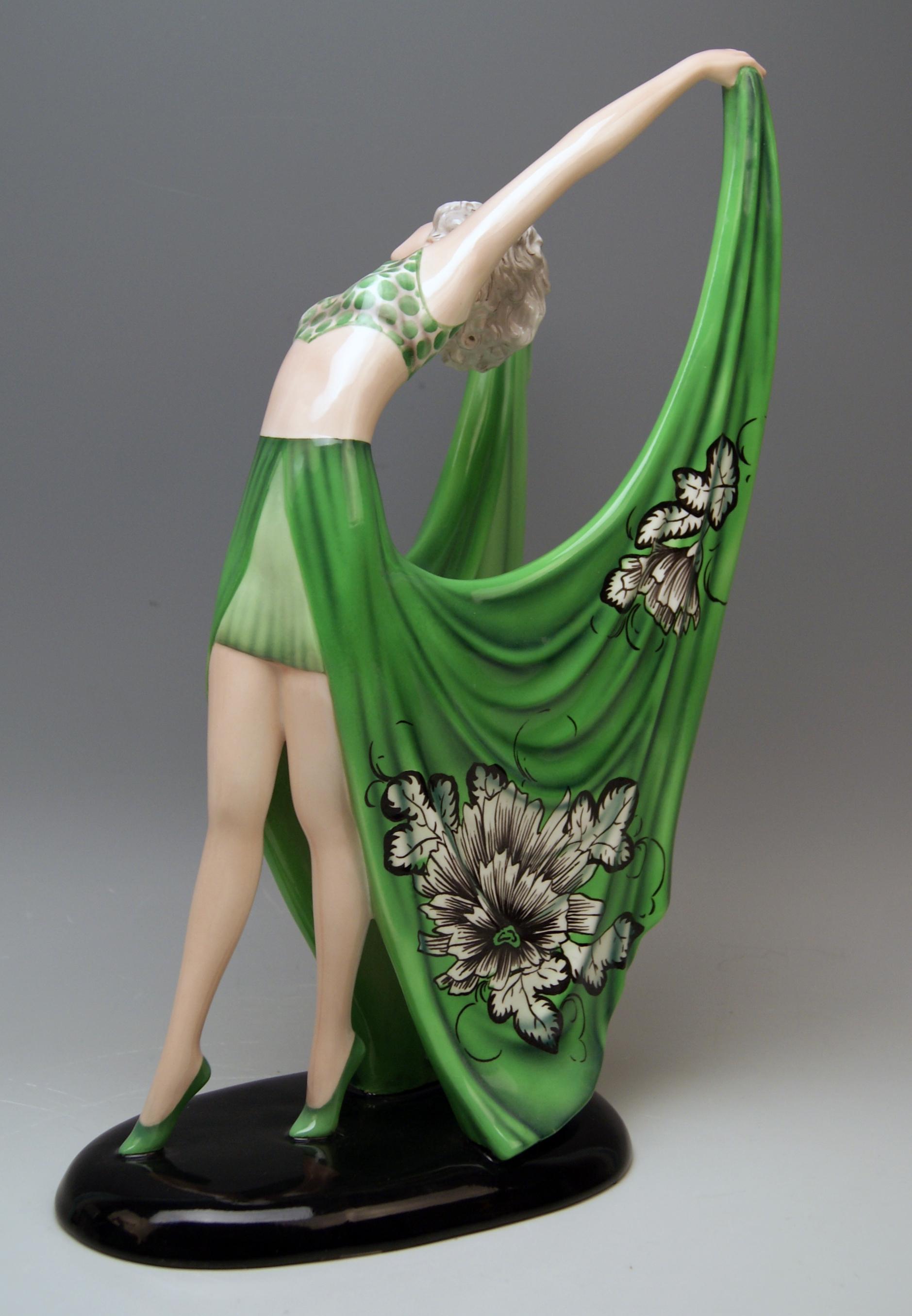 Goldscheider Vienna dancing lady clad in green dress

Designed by Stefan (= Stephen) Dakon (1904-1992), circa 1935 / made 1935-1936. 
model number 7195 / 1336 / 4

Hallmarked:
Goldscheider WIEN (= VIENNA) stamp mark
Made in Austria /
