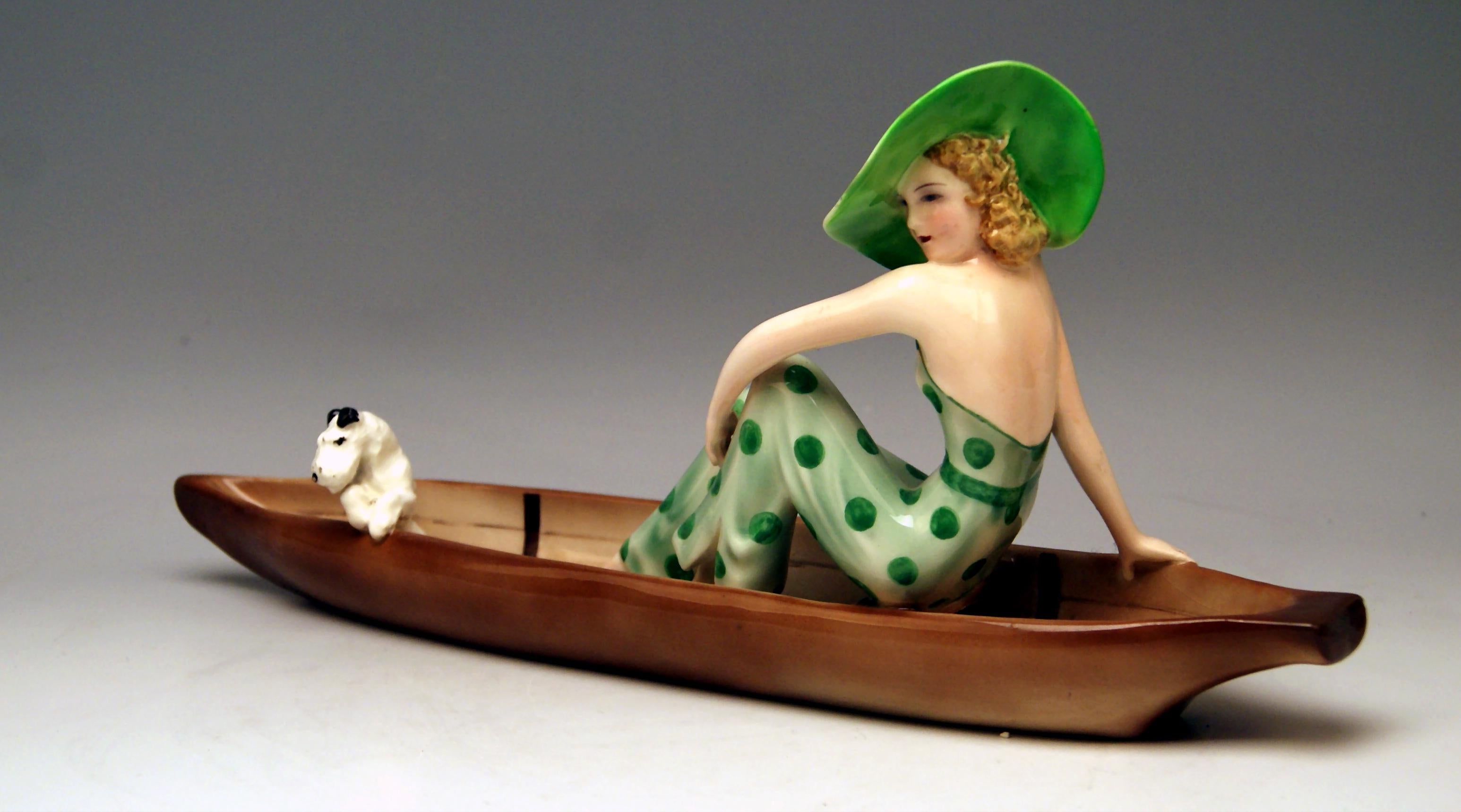 Goldscheider Vienna Lady in Canoe, with Fox Terrier.
Model created 1935 by Stefan (= Stephen) Dakon (1904 - 1992).
Made circa 1936-37. 
model number 7256 / 162 / 16

Hallmarked:
painter's sign & two signatures 'Dakon' at reverse side of canoe
